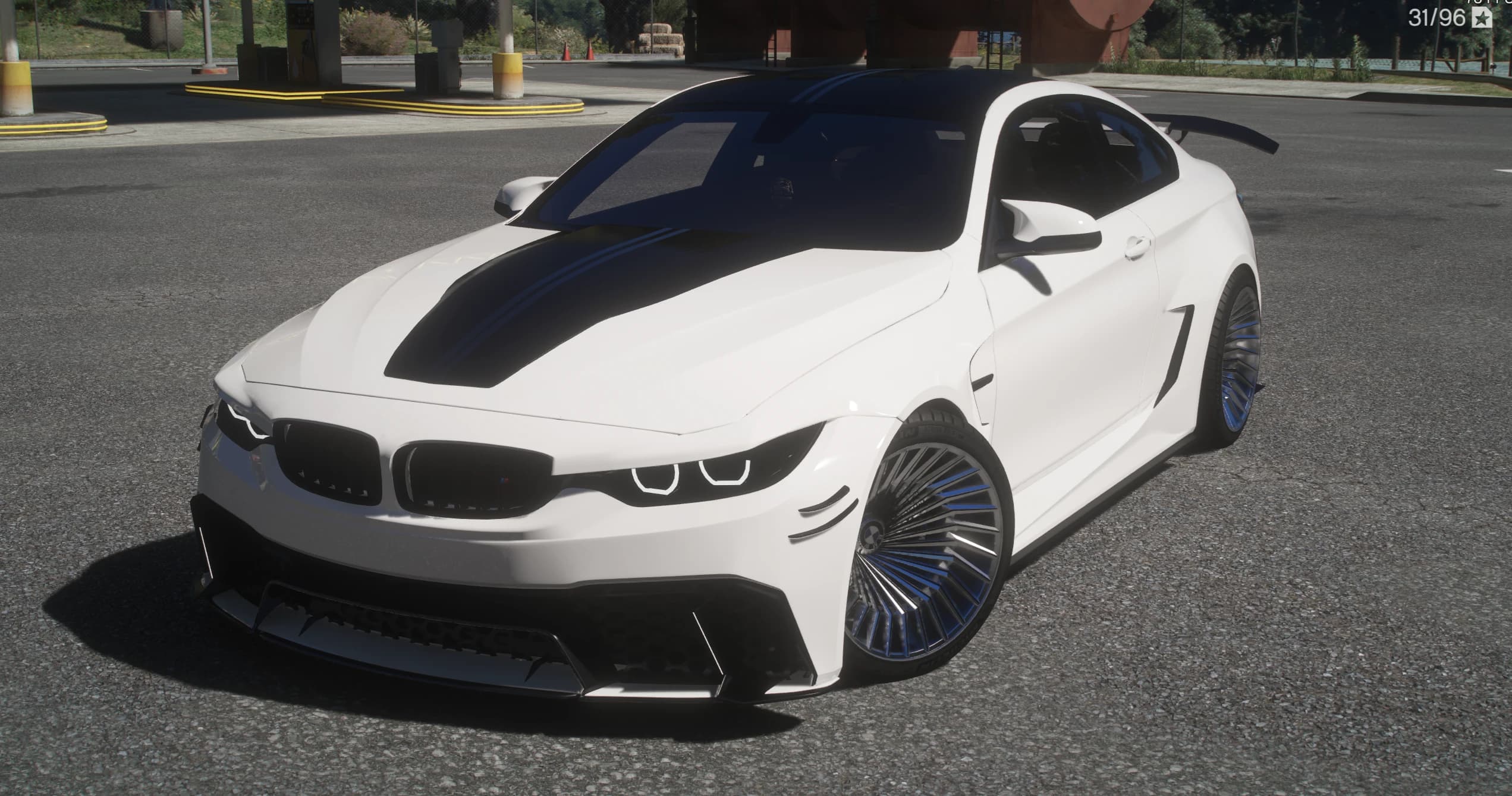 Front three quarter view of the white widebody M4 with twin black hood stripes, a black roof, canards on the front splitter and blue accented turbofan style wheels