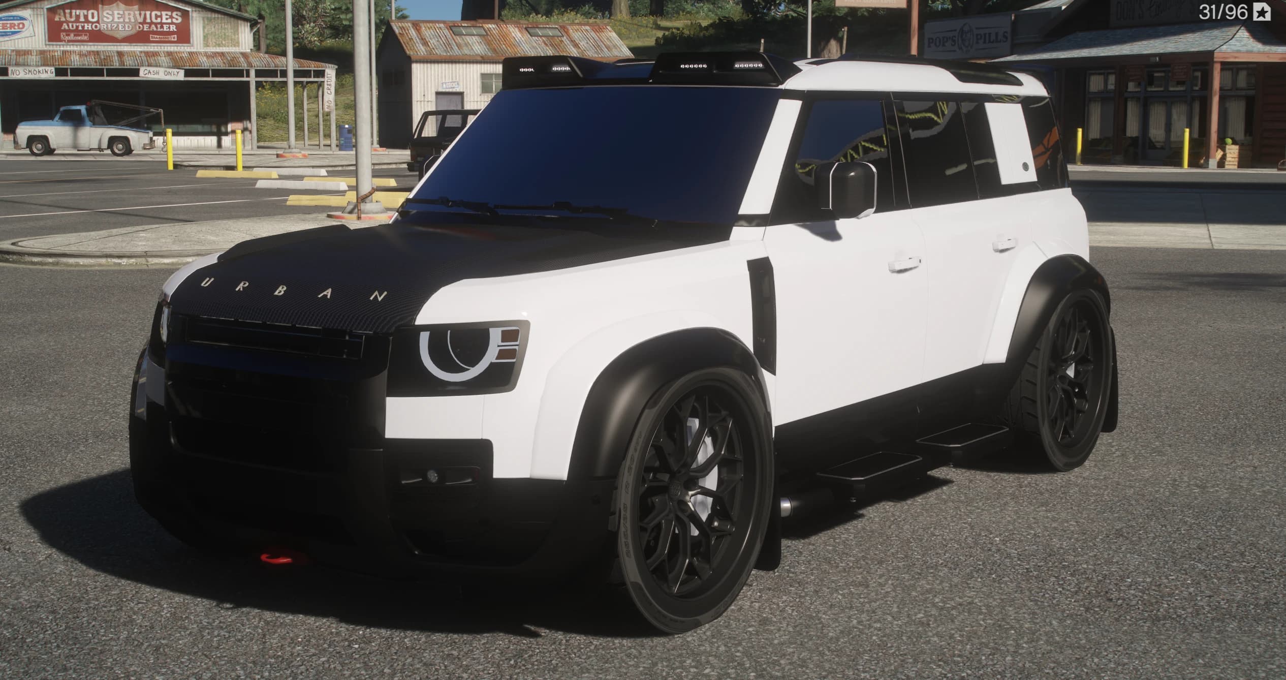 Front three quarter view of the white build with its carbon bonnet, white halo daytime lights, black wide arches and side steps
