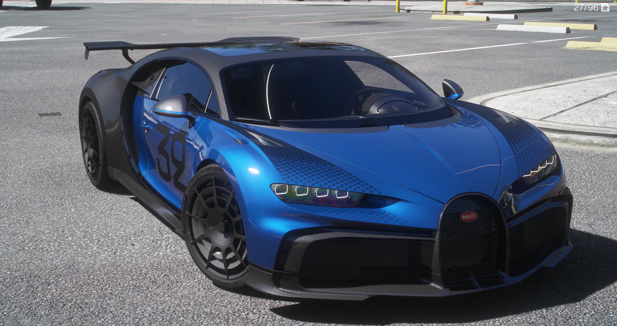 Bugatti Chiron Pur Sport in blue over exposed carbon, front three-quarter view on a city street, with the black number 32 on the door, the dotted graphic across the bonnet, the horseshoe grille and the fixed carbon rear wing