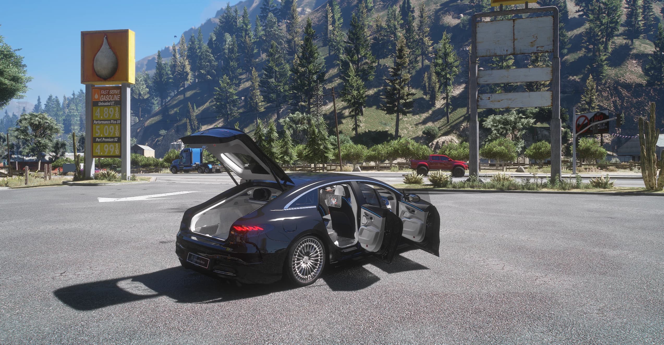 The EQS at a roadside petrol station in the hills with the tailgate and both right-hand doors open, showing the white leather cabin, the boot space and the blue ambient lighting