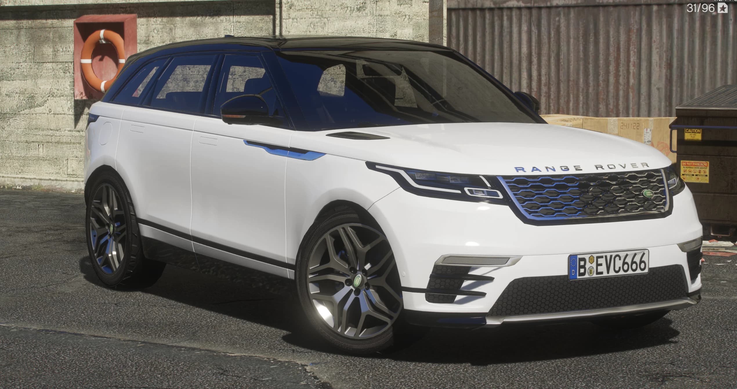 Front three quarter view of the white Velar with its black contrast roof, blue tinted grille mesh and grey split spoke wheels