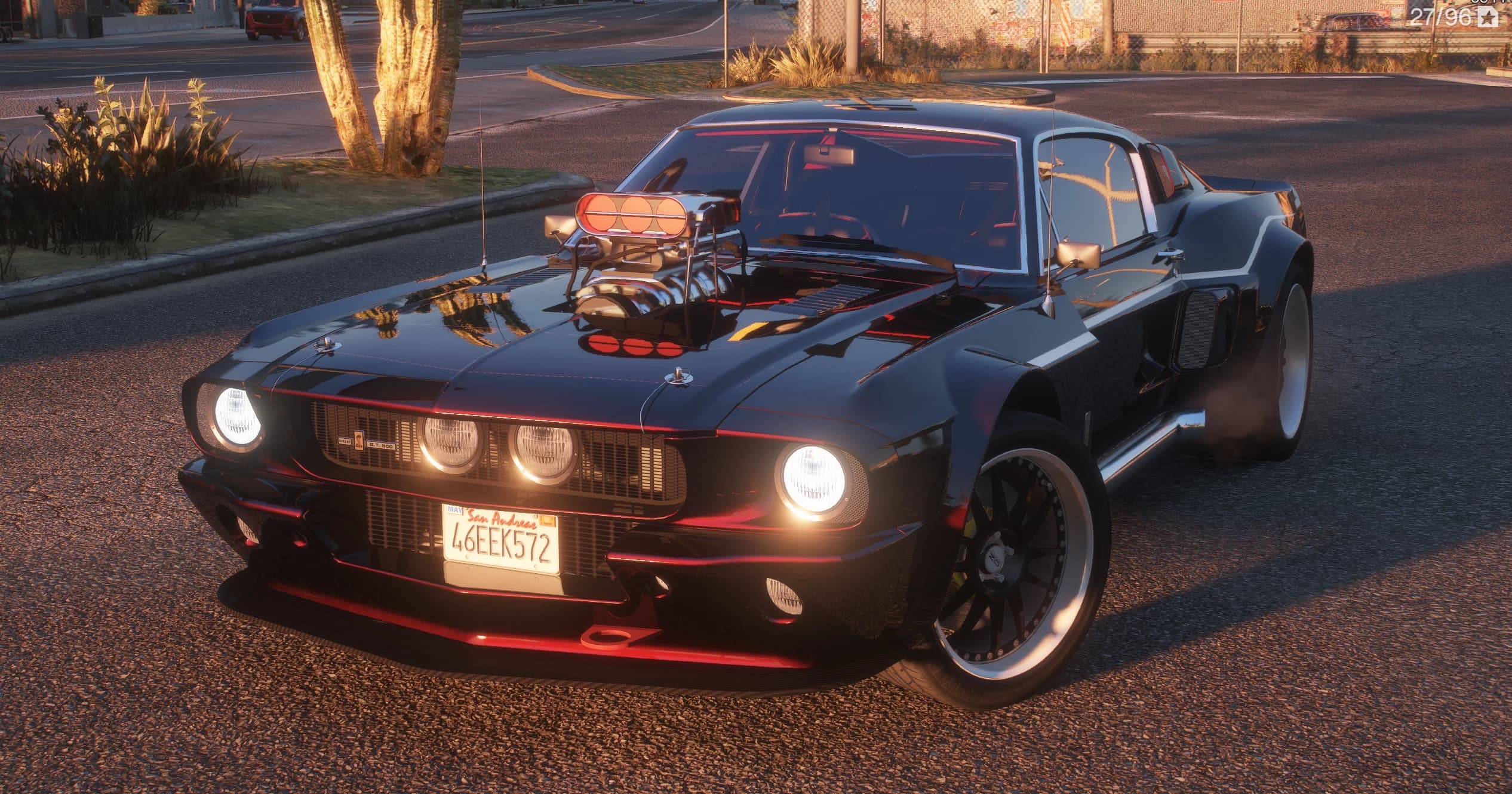 1967 Shelby Mustang GT500 in black with red pinstriping, front three-quarter at sunset, chromed supercharger sticking out of the hood, four round headlights lit and a San Andreas plate reading 46EEK572