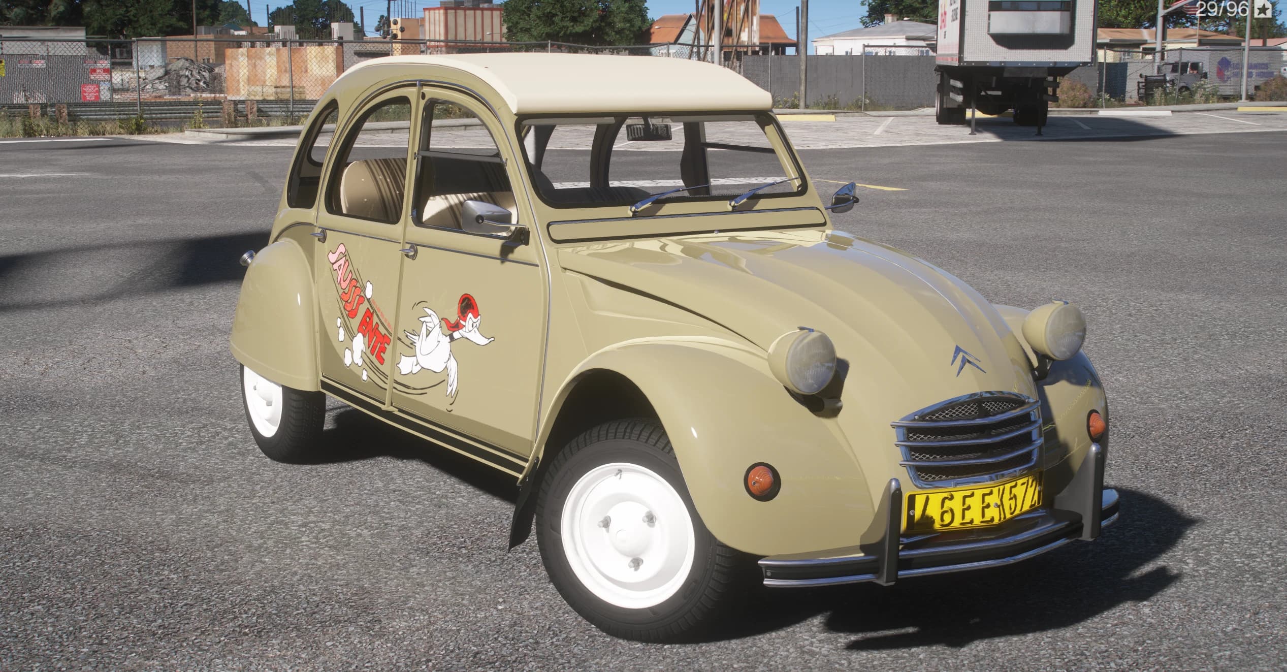 Front three-quarter of the 2CV with the cream roof closed, chrome grille, Citroen chevrons and yellow plate