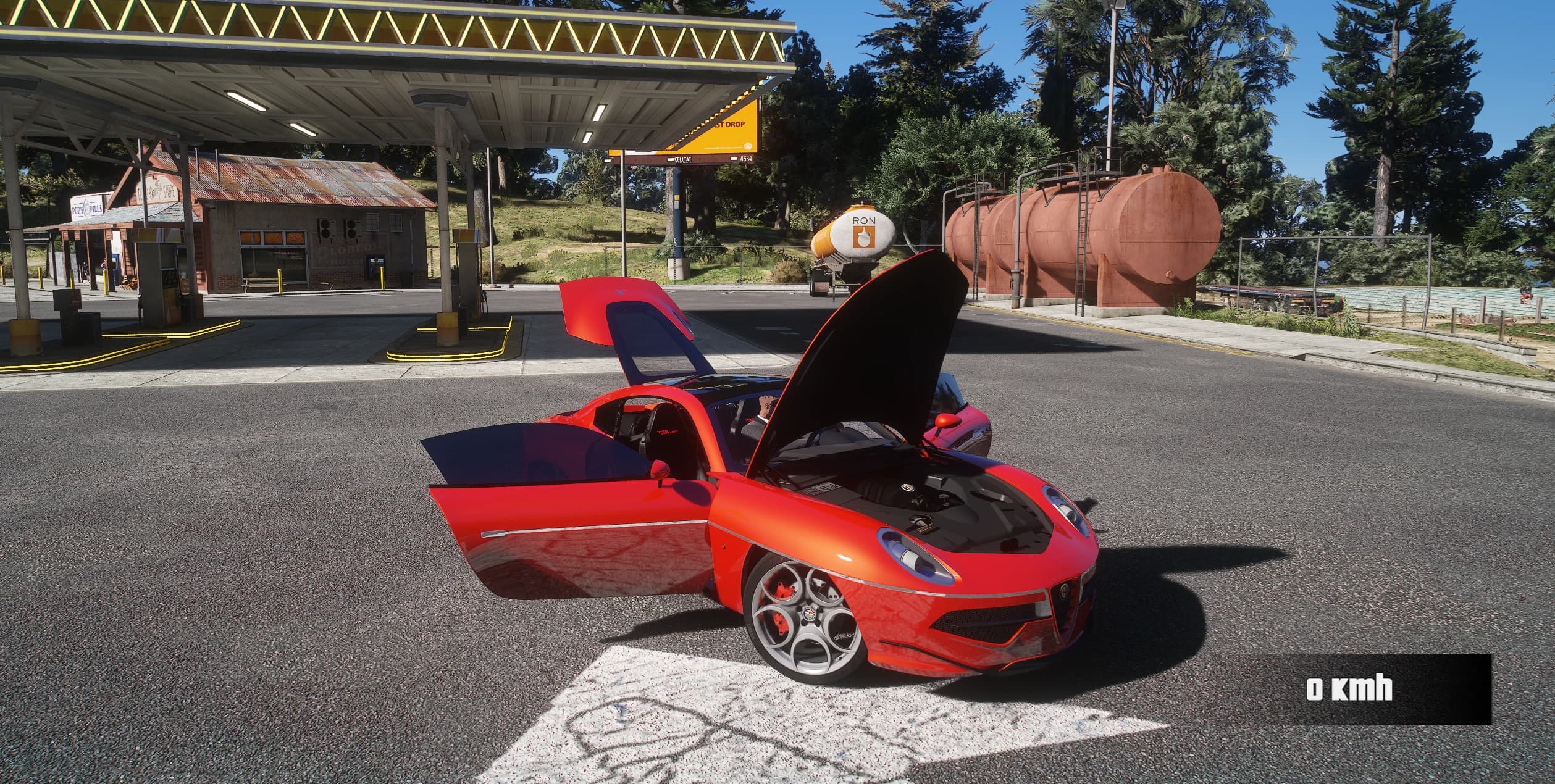 The Disco Volante with both doors and the bonnet open at a rural gas station, showing the engine and red interior
