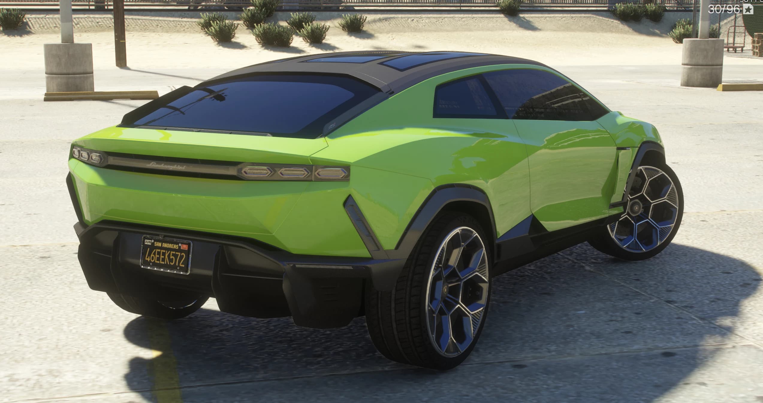 Rear three-quarter of the green Lanzador showing the full-width light bar with the Lamborghini script, the rear diffuser and a San Andreas licence plate reading 46EEK572