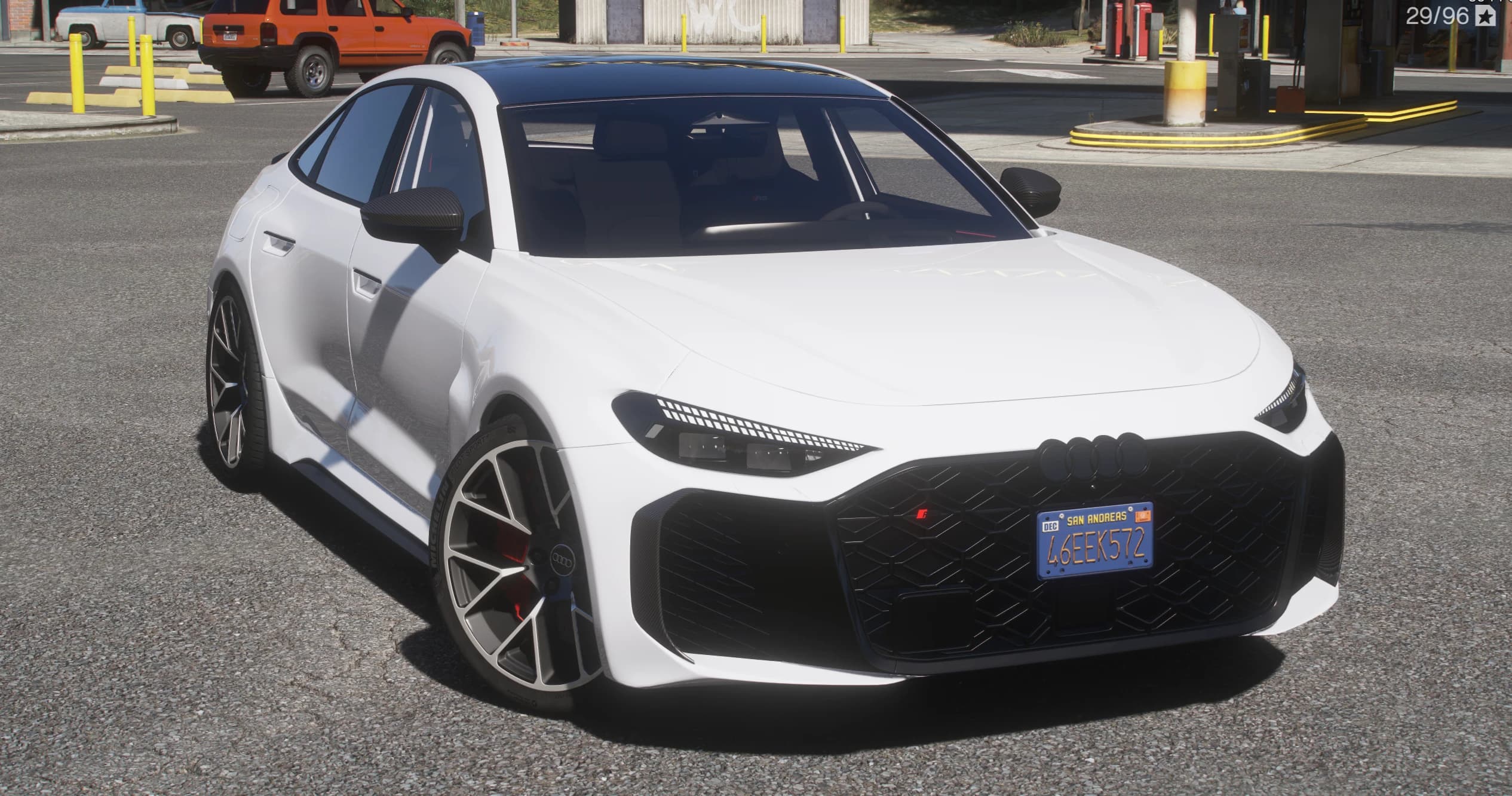 White 2026 Audi RS5 Sportback, front three-quarter view with the wide honeycomb grille, four-ring badge and five-arm wheels with red brake calipers