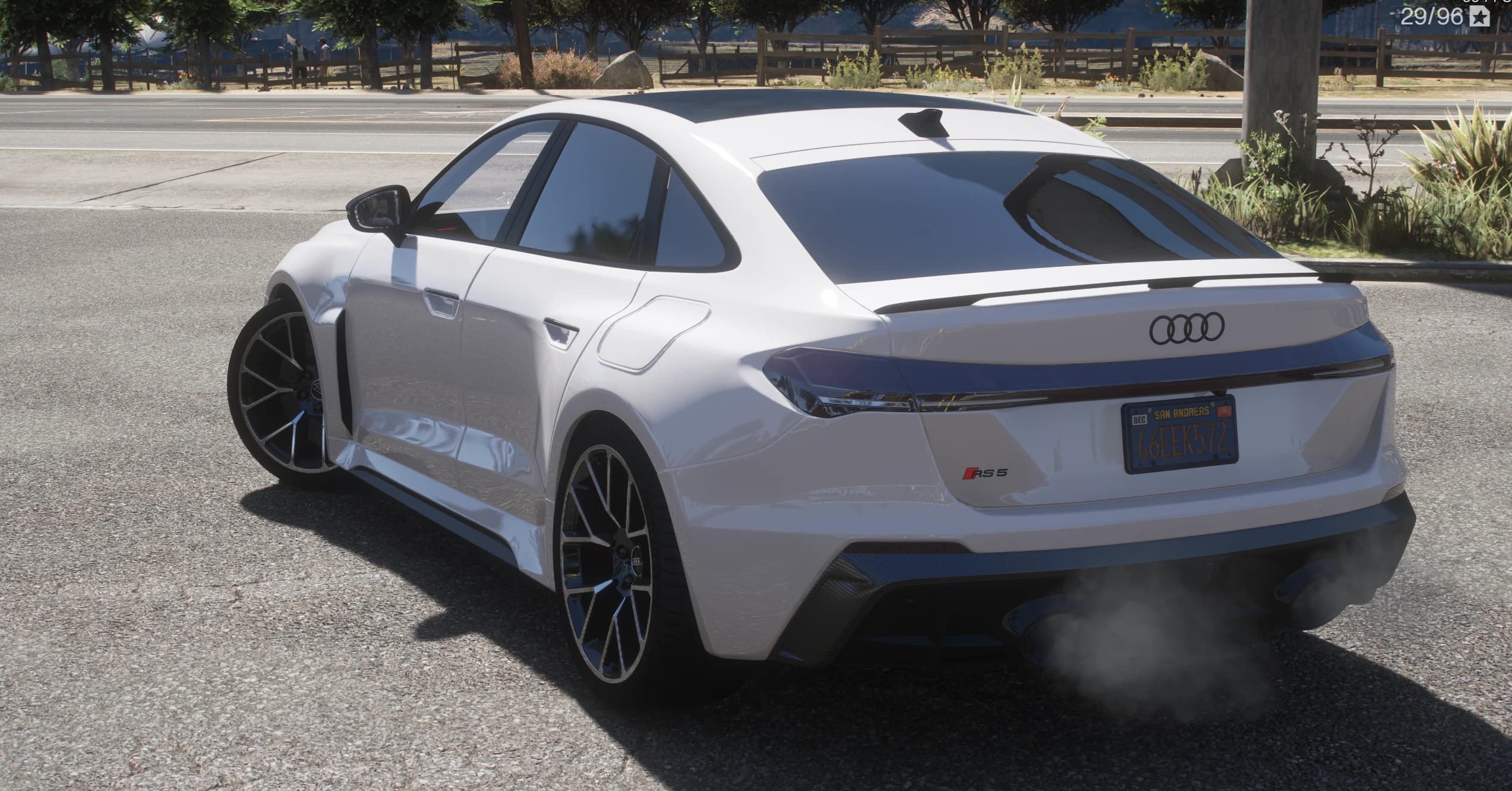 Rear three-quarter of the white RS5 with the four-ring badge on the boot, the RS 5 lettering and twin exhaust tips