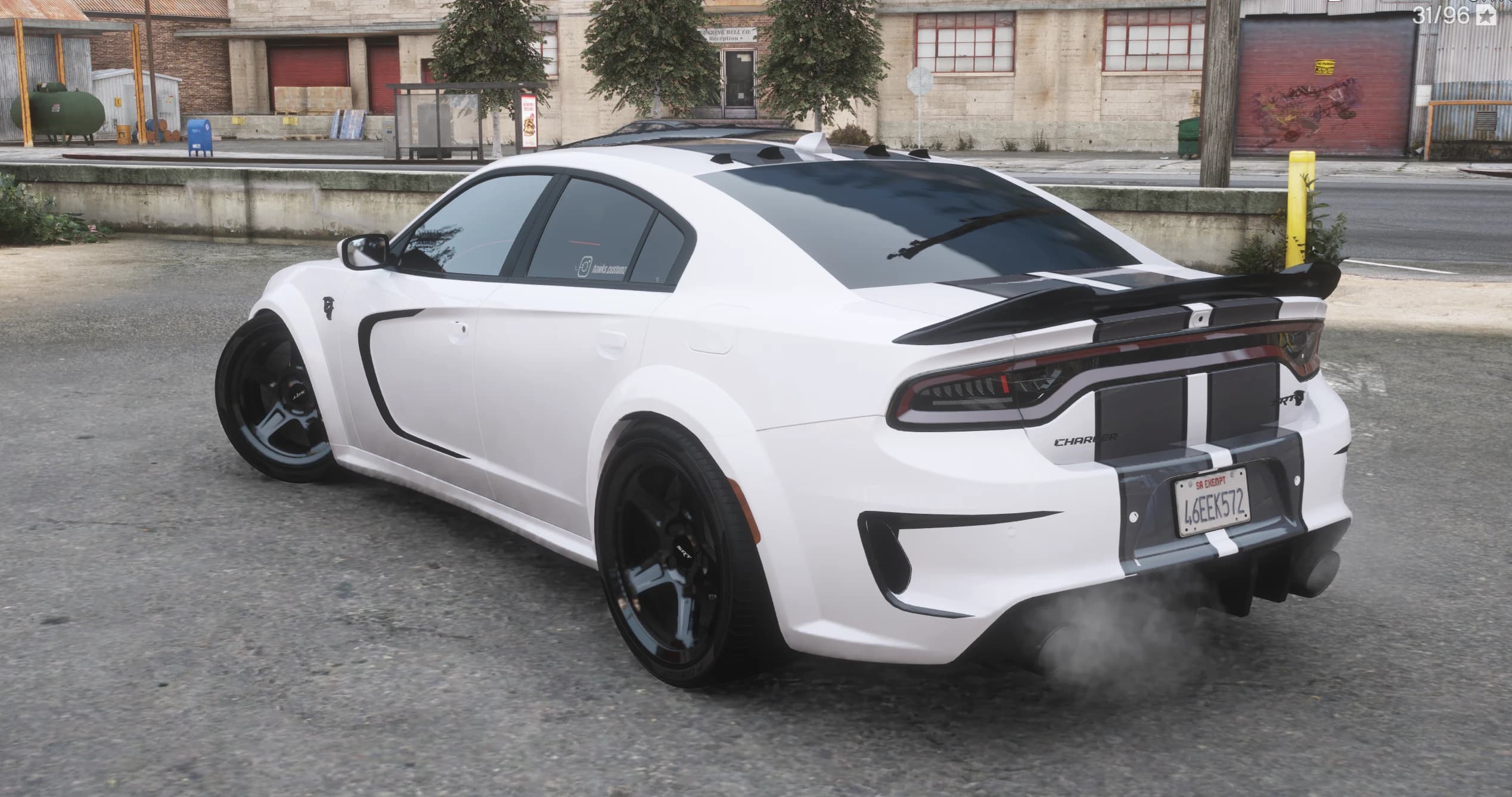 Rear three quarter view with the black ducktail spoiler, CHARGER and SRT badges, vortex generators on the roof and the widebody arches