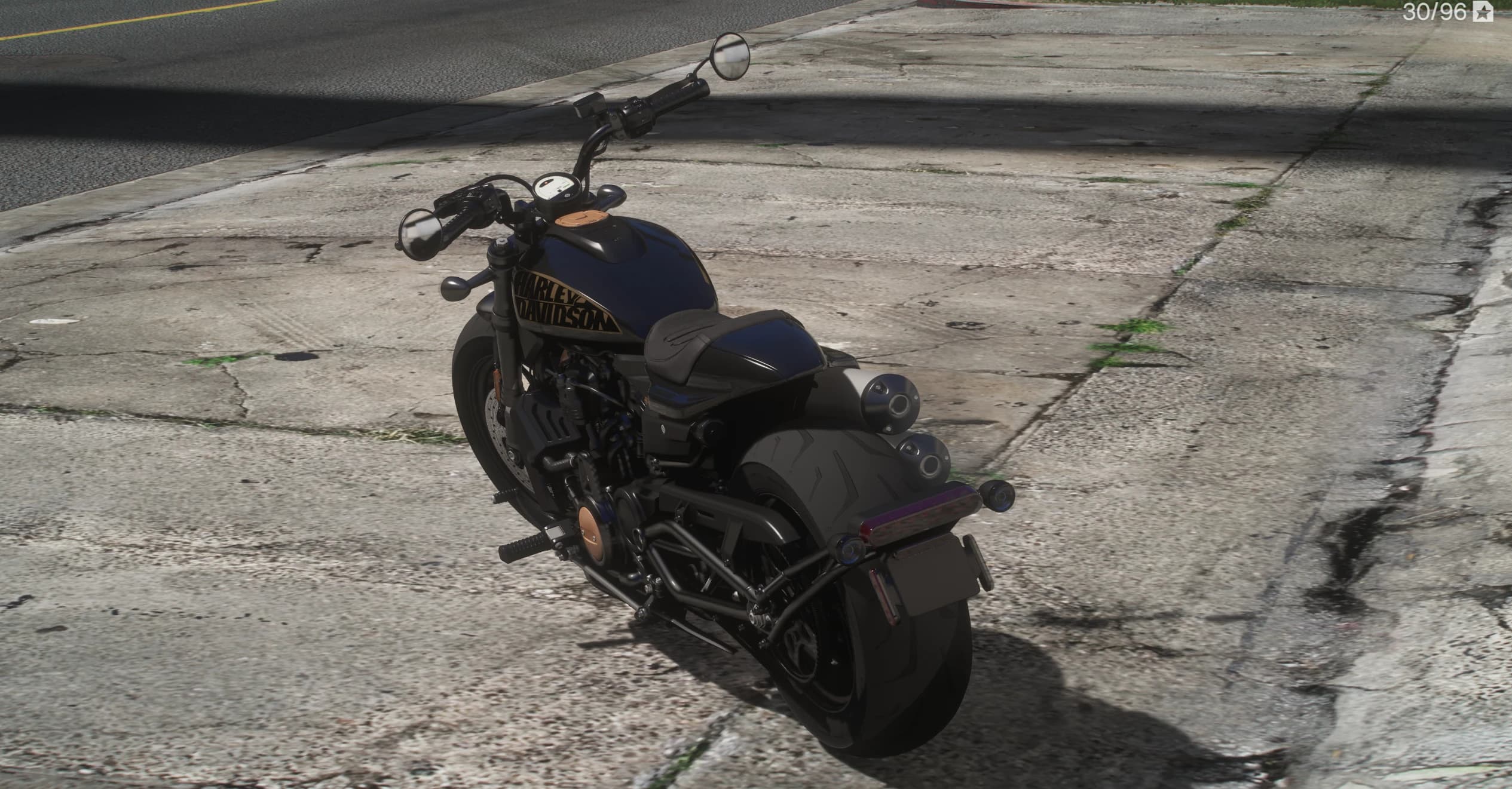 High-angle rear three-quarter of the black Sportster S showing the solo seat, the stacked right-side exhausts, the minimal rear fender and the slim purple-tinted LED taillight