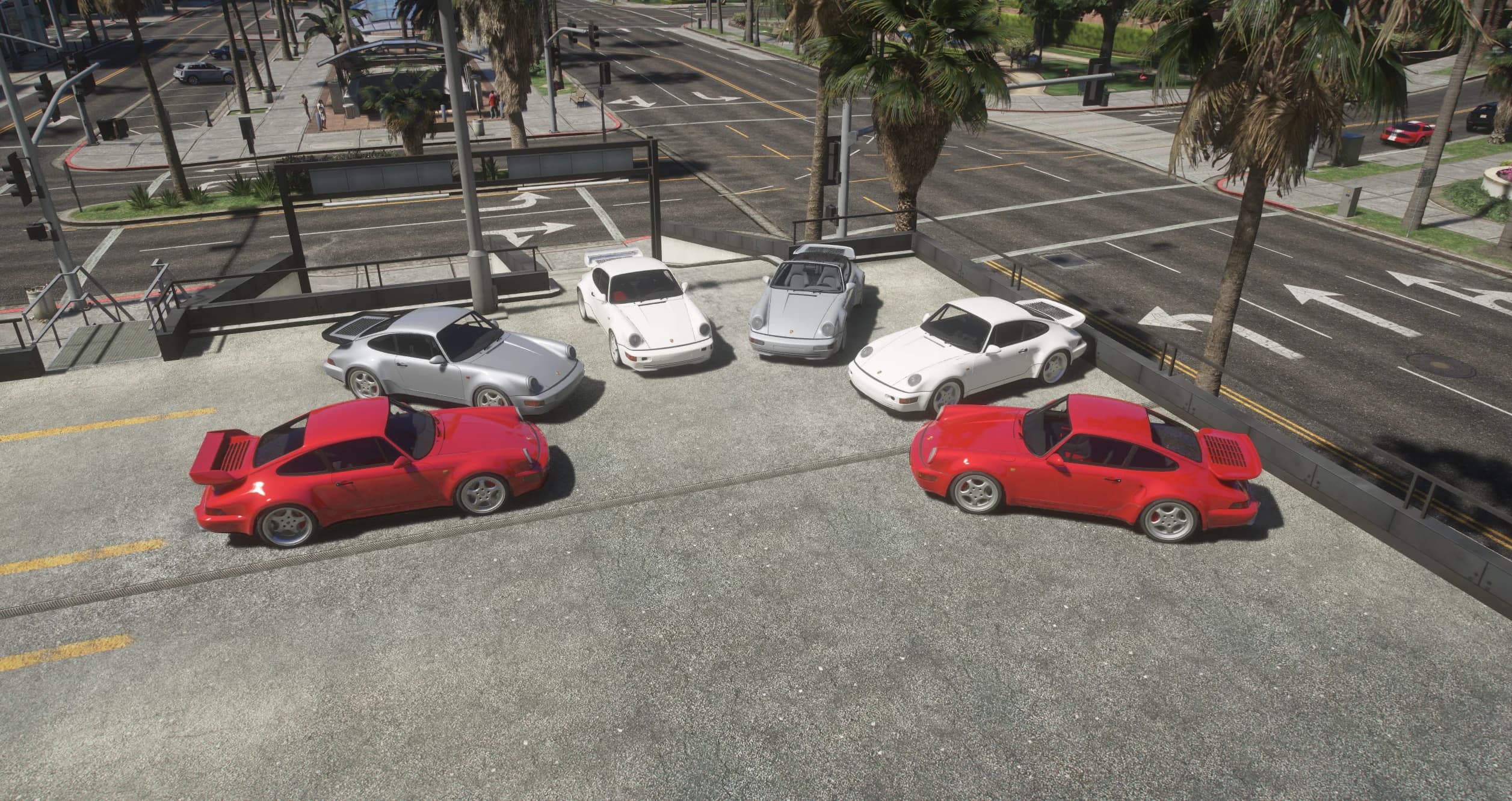 The whole 964 pack lined up on a parking deck by a city intersection, whale tail Turbos beside the narrow body cars and the cut down windshield Speedster