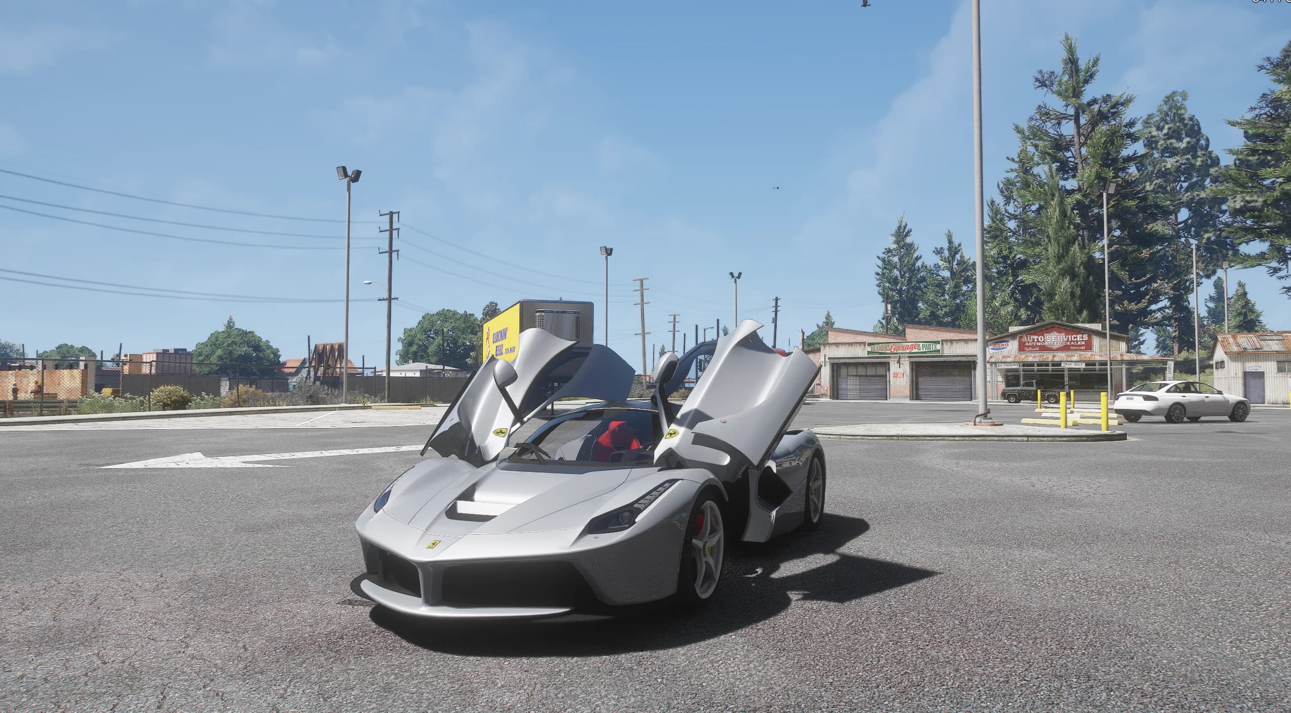The LaFerrari parked at a rural crossroads next to an Auto Services garage with both butterfly doors raised, showing the red seats inside