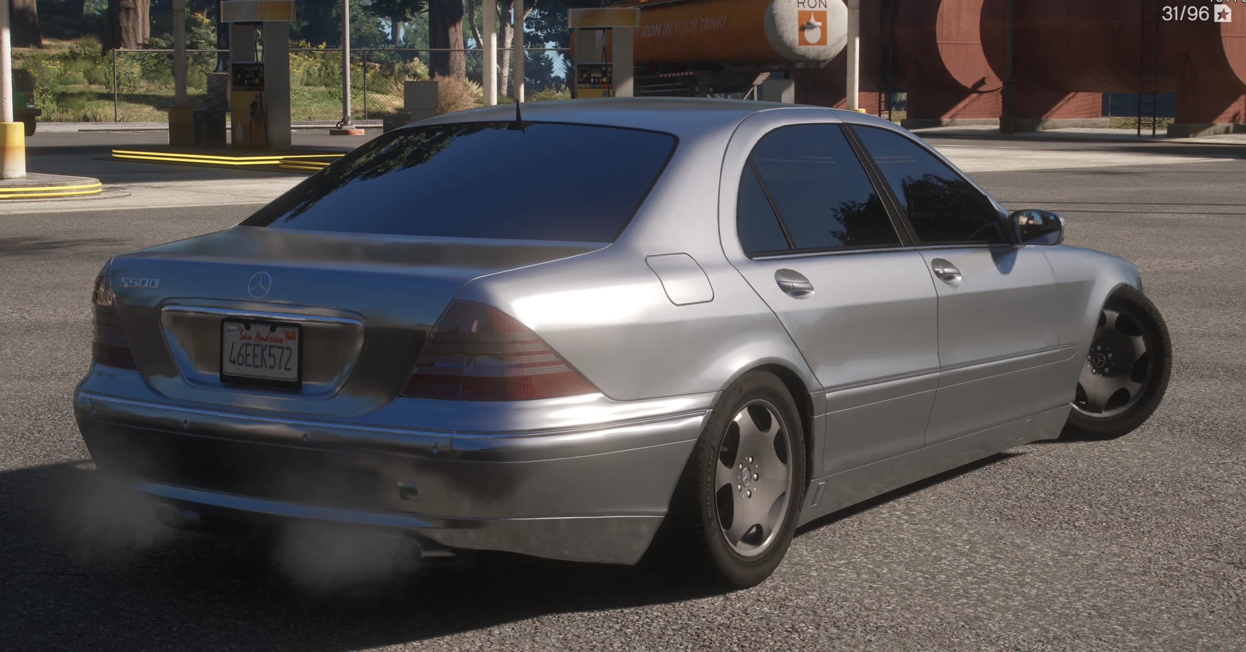 Rear three quarter at a gas station showing the S500 boot badge, the San Andreas plate, the Michelin lettering on the tyres and light exhaust smoke