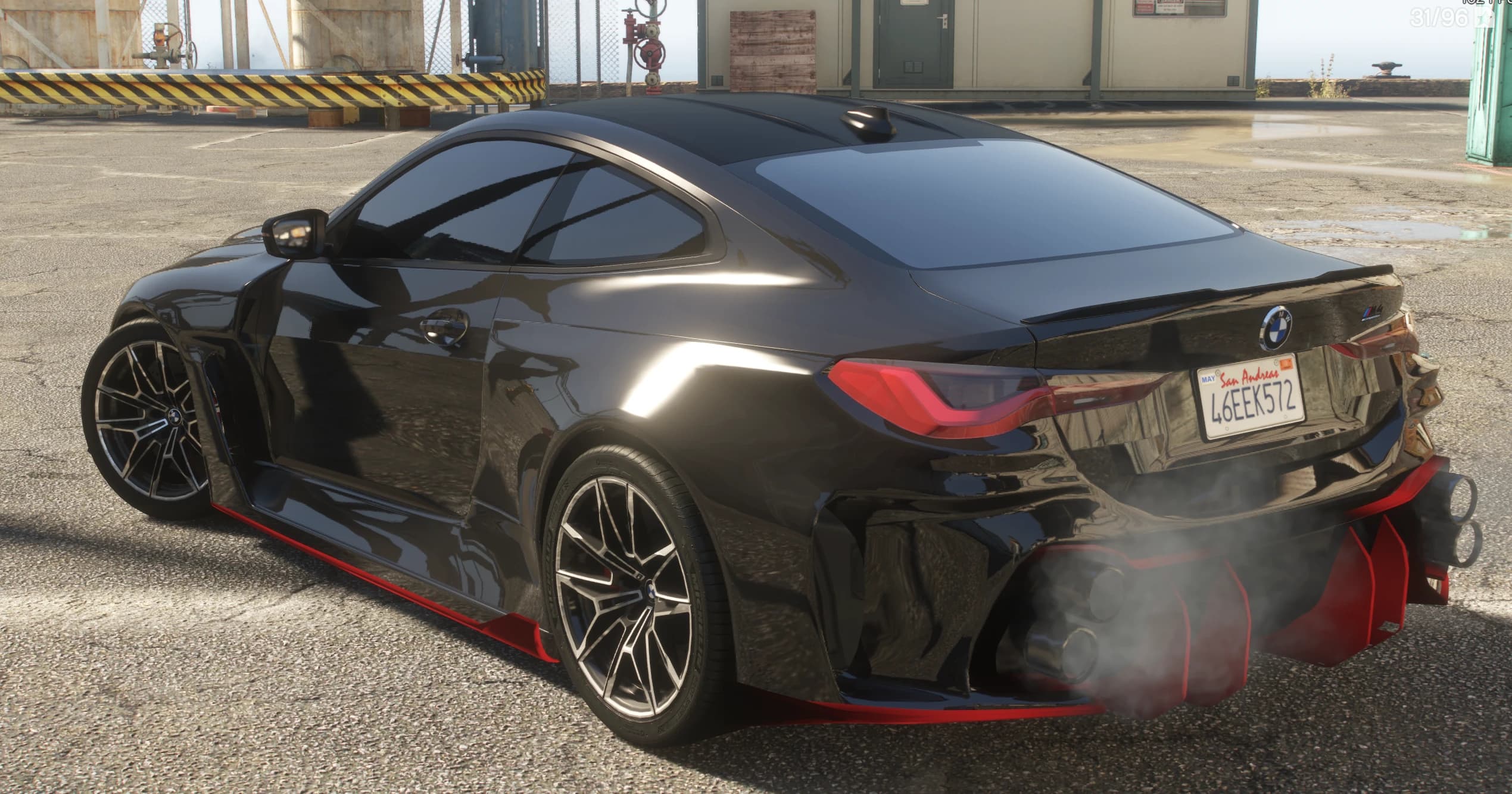 Rear three quarter view with the ducktail spoiler, San Andreas plate and the red diffuser blades framing the stacked quad exhaust tips