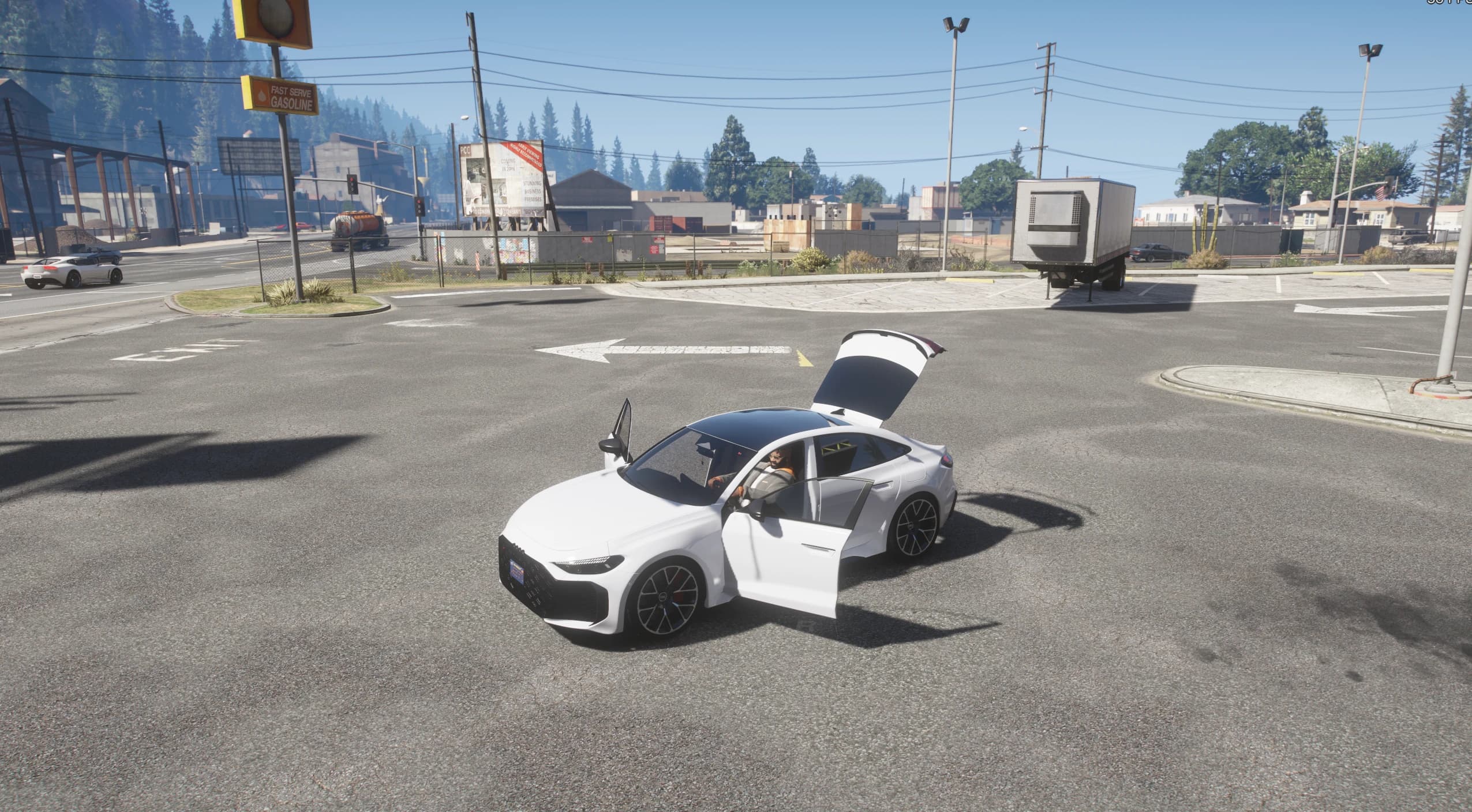 The white RS5 at a crossroads with the boot and a door open, seen from a high three-quarter angle with the driver inside