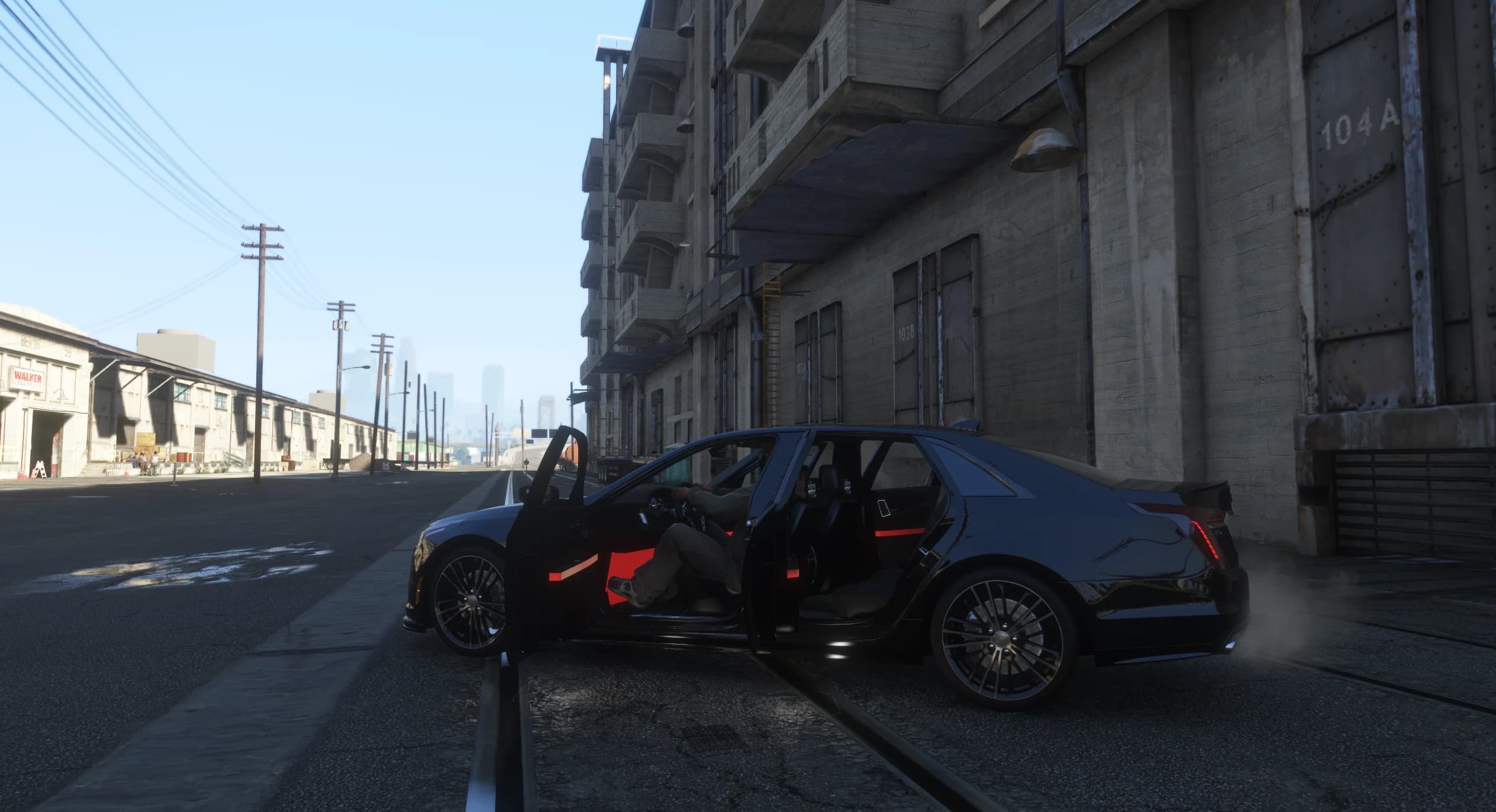 Side view with all four doors open showing the red lit door inserts and the driver at the wheel on an industrial street