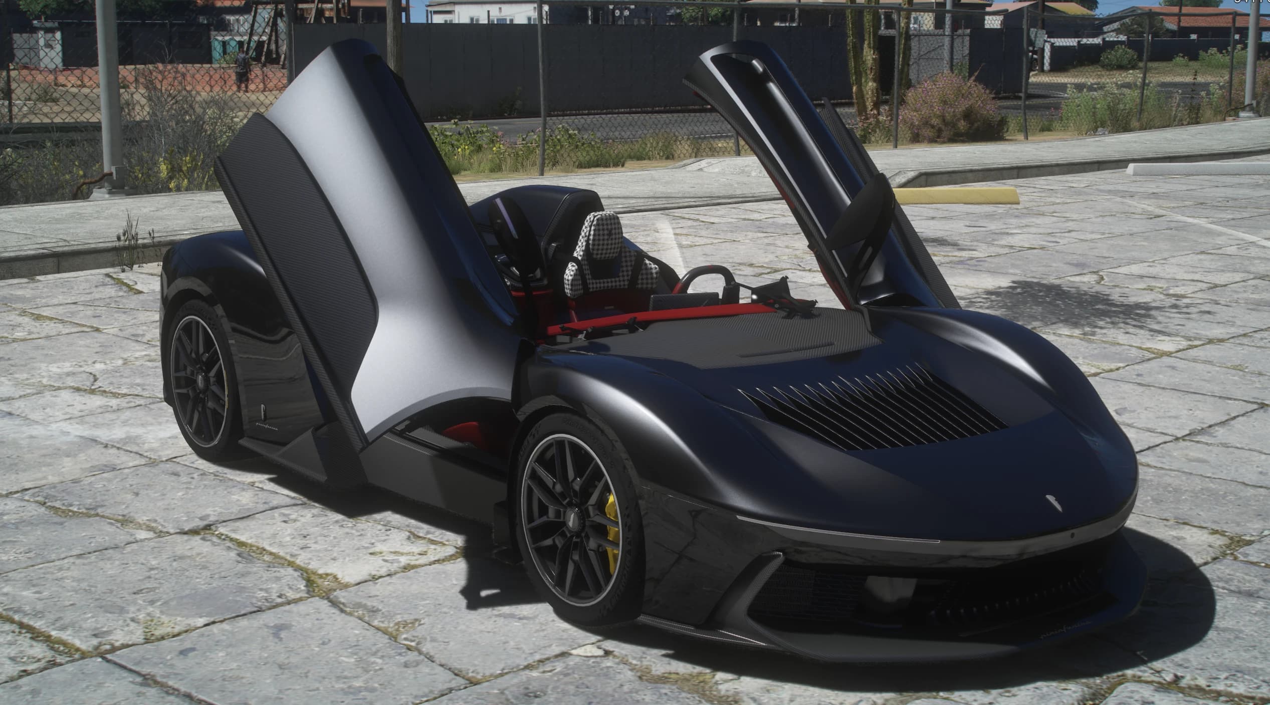 The B95 with both butterfly doors raised on a stone paved lot, showing the houndstooth seat and the red interior frame under the open sky