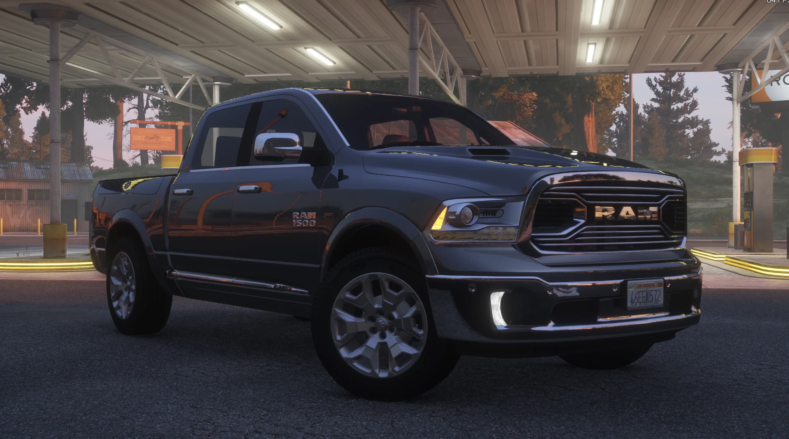 Front three quarter view of the dark grey Ram 1500 under a gas station canopy at dusk, with the chrome RAM grille, chrome mirrors and polished alloy wheels