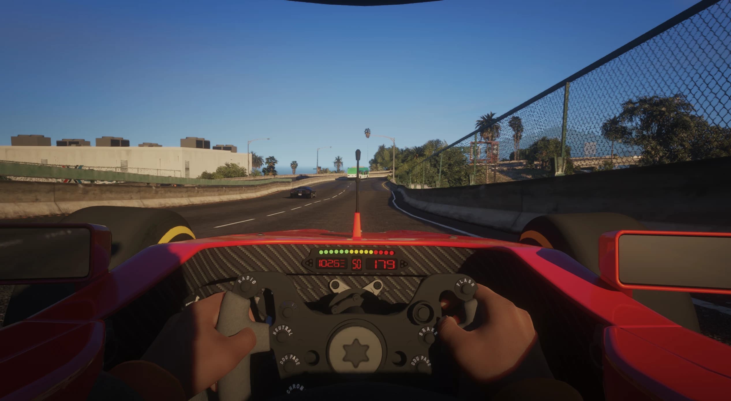 First person cockpit view at speed with the carbon fibre wheel, shift lights and digital speed readout on a Los Santos freeway