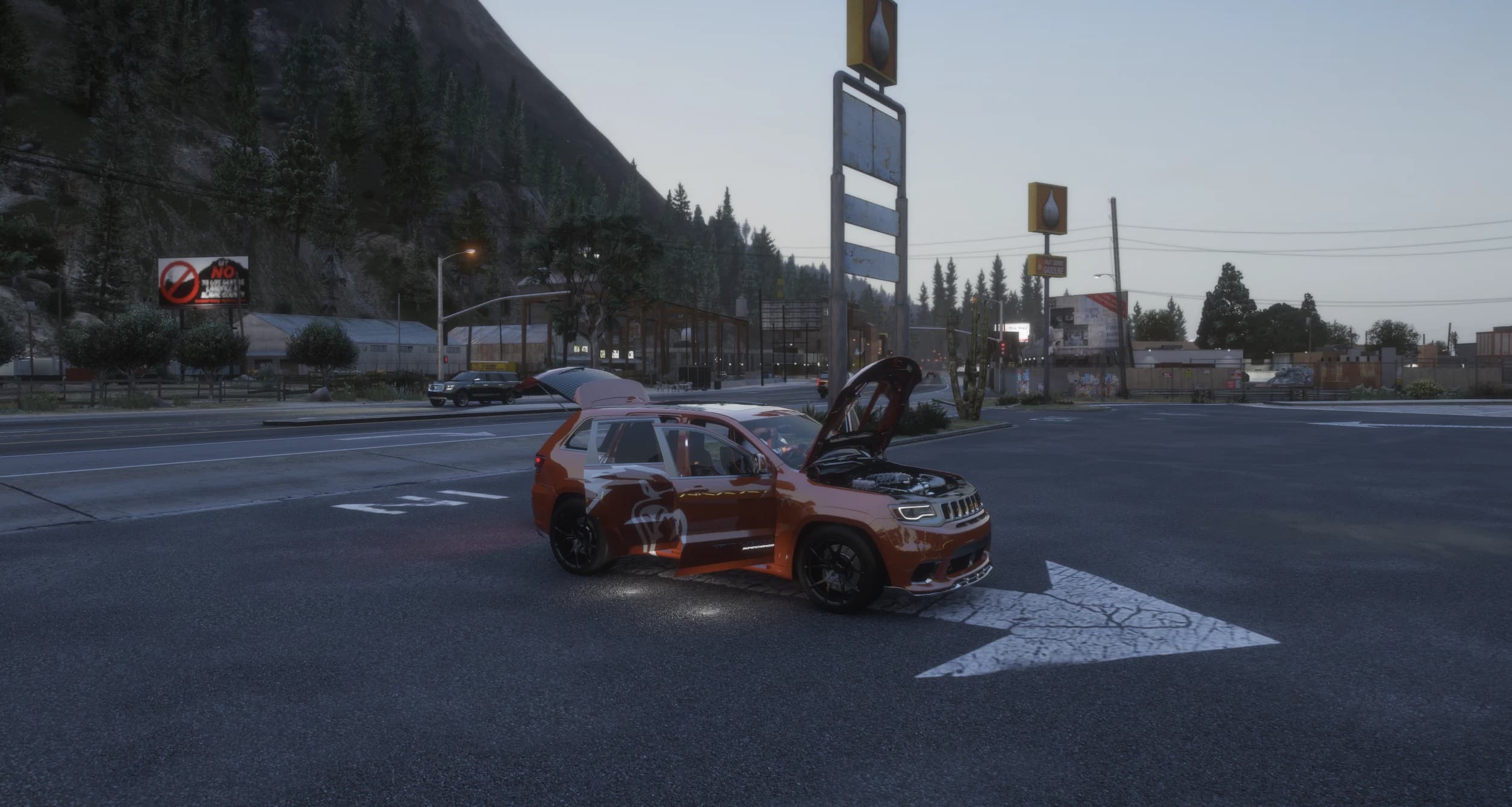 Orange Trackhawk livery variant with the doors, bonnet and boot open at a crossroads at dusk, showing the lion graphic on the side