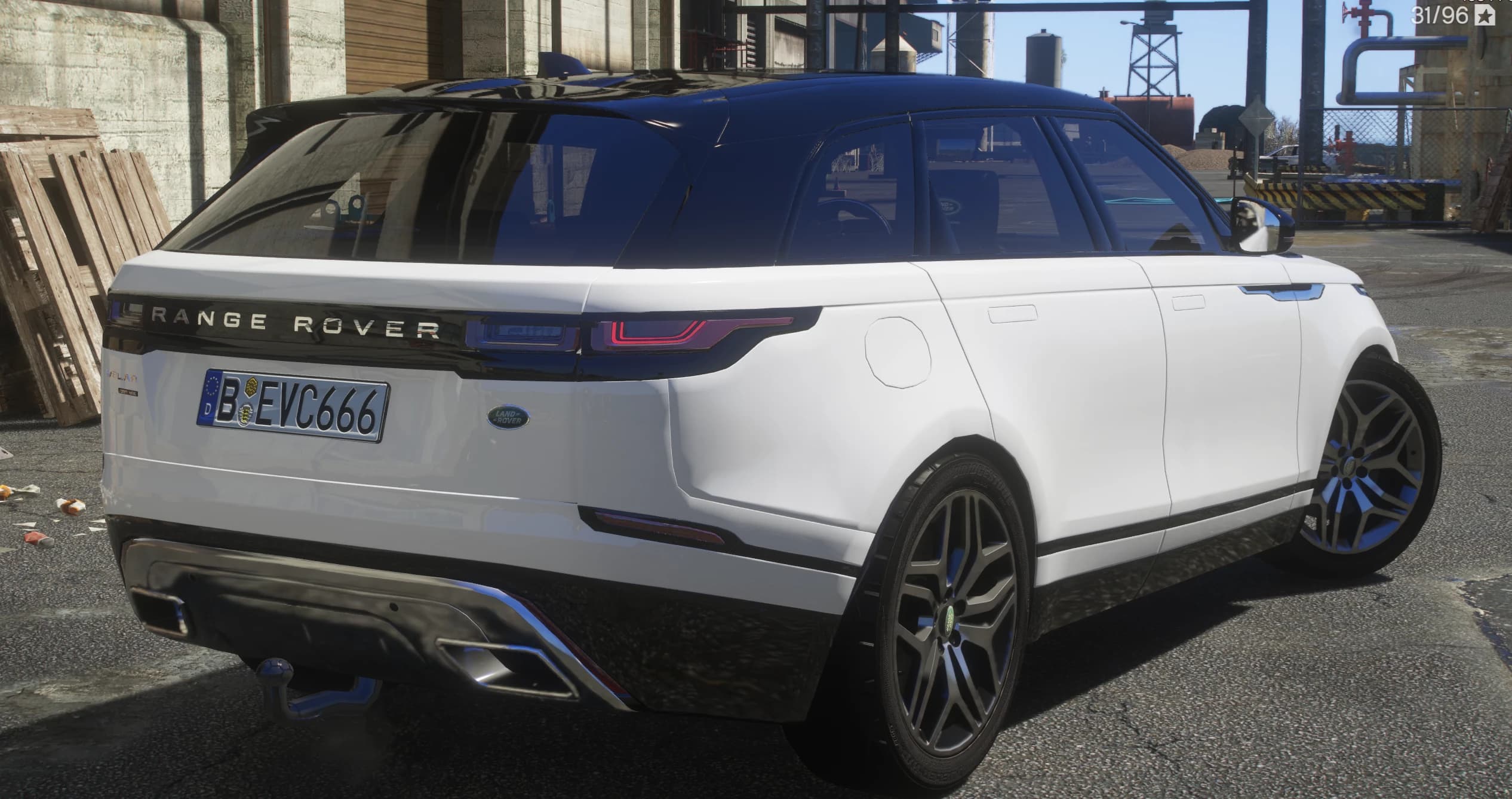 Rear three quarter view showing the slim wraparound tail lights, the Range Rover lettering on the tailgate and the tow ball under the bumper