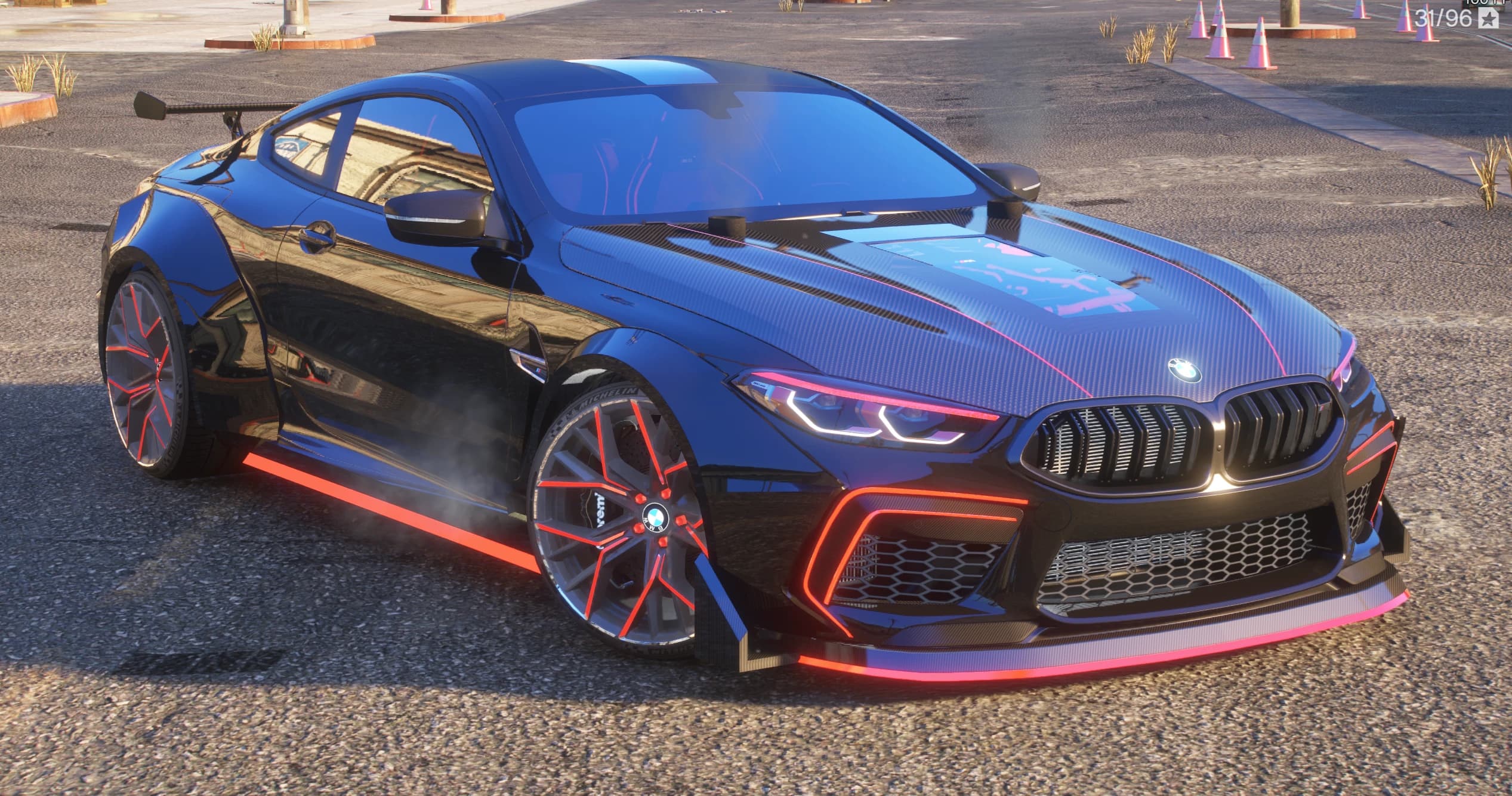 Daytime front three quarter view showing the carbon bonnet with its glass window, red pinstripes, red trimmed intakes and wheels with red spokes