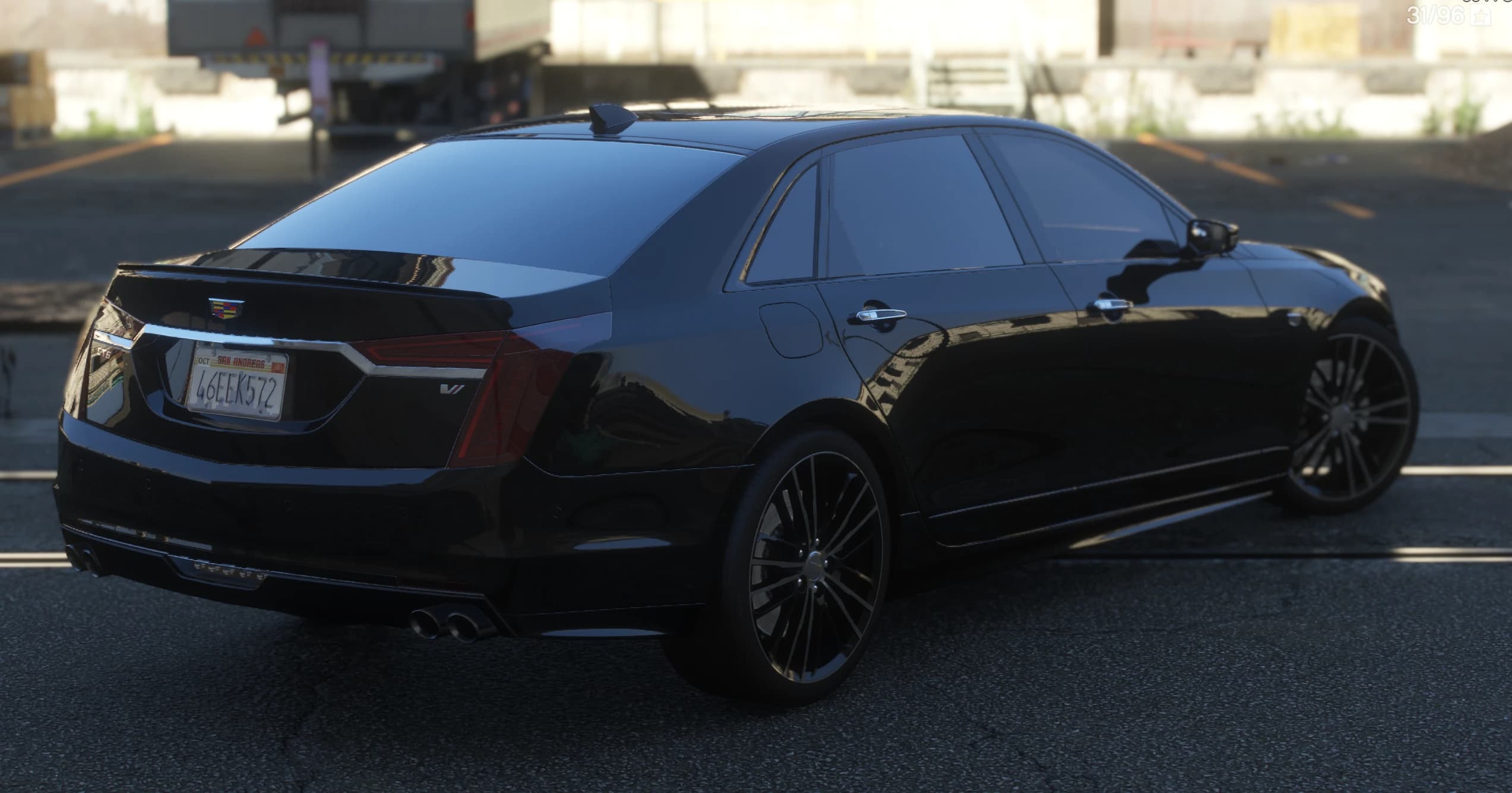 Rear three quarter view showing the vertical tail lights, the V badge on the boot lid and four exhaust tips