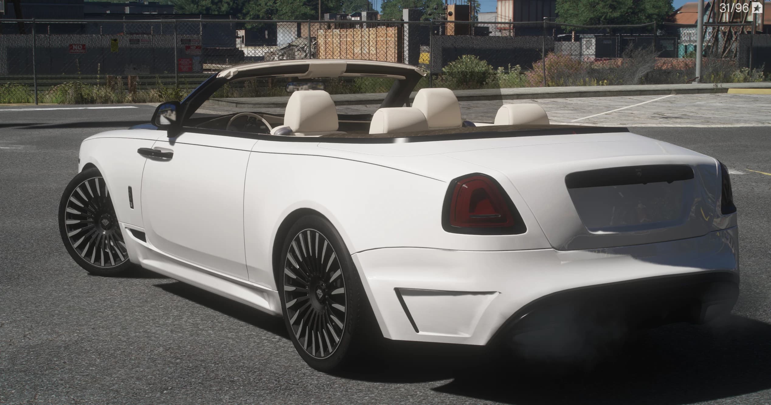 Rear three quarter view showing the four cream headrests, the wooden rear deck, smoked taillights and the black diffuser of the Onyx kit