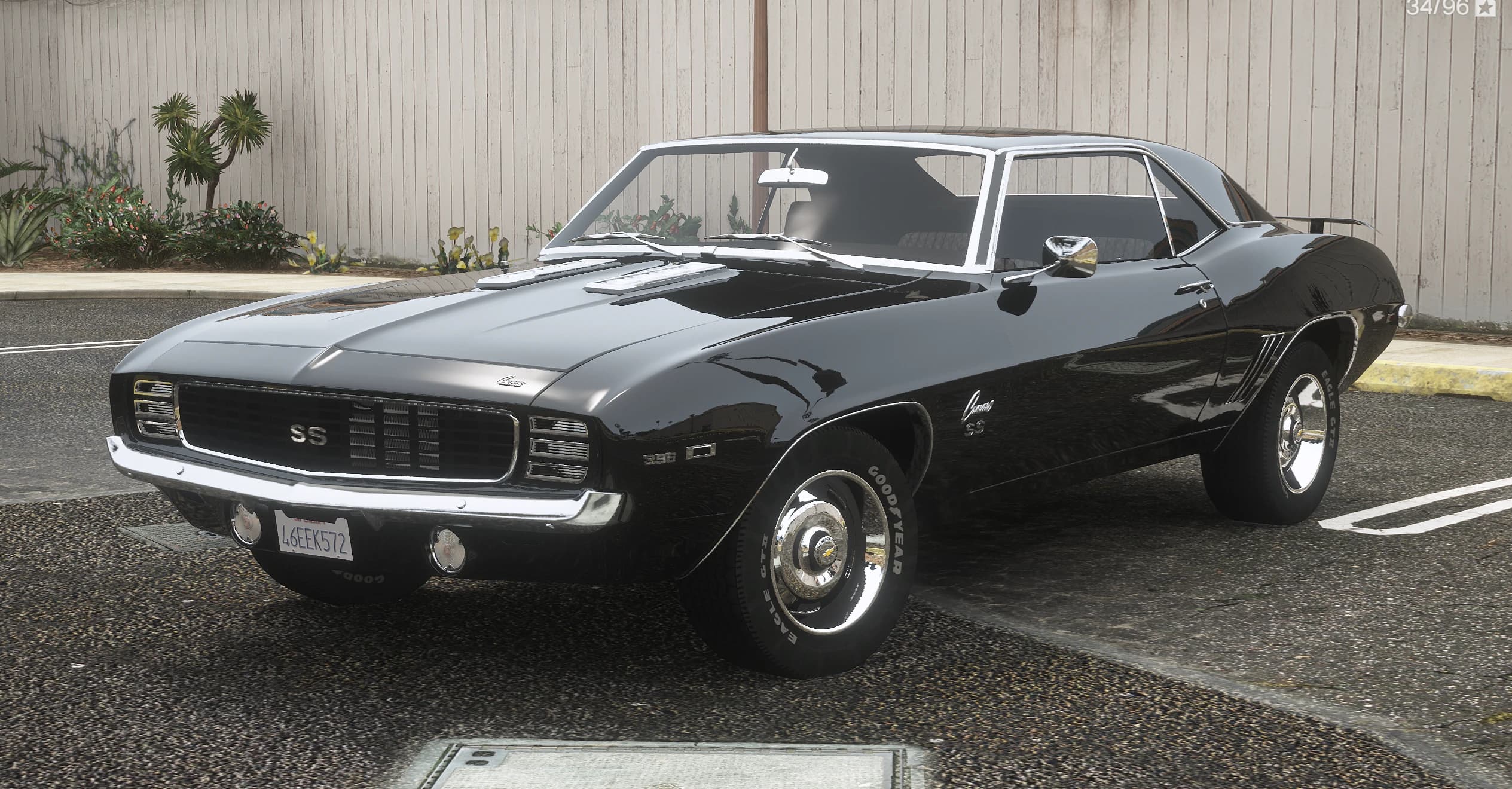Front three quarter view of the black 1969 Camaro SS with the SS grille badge, chrome bumper and white letter Goodyear tires