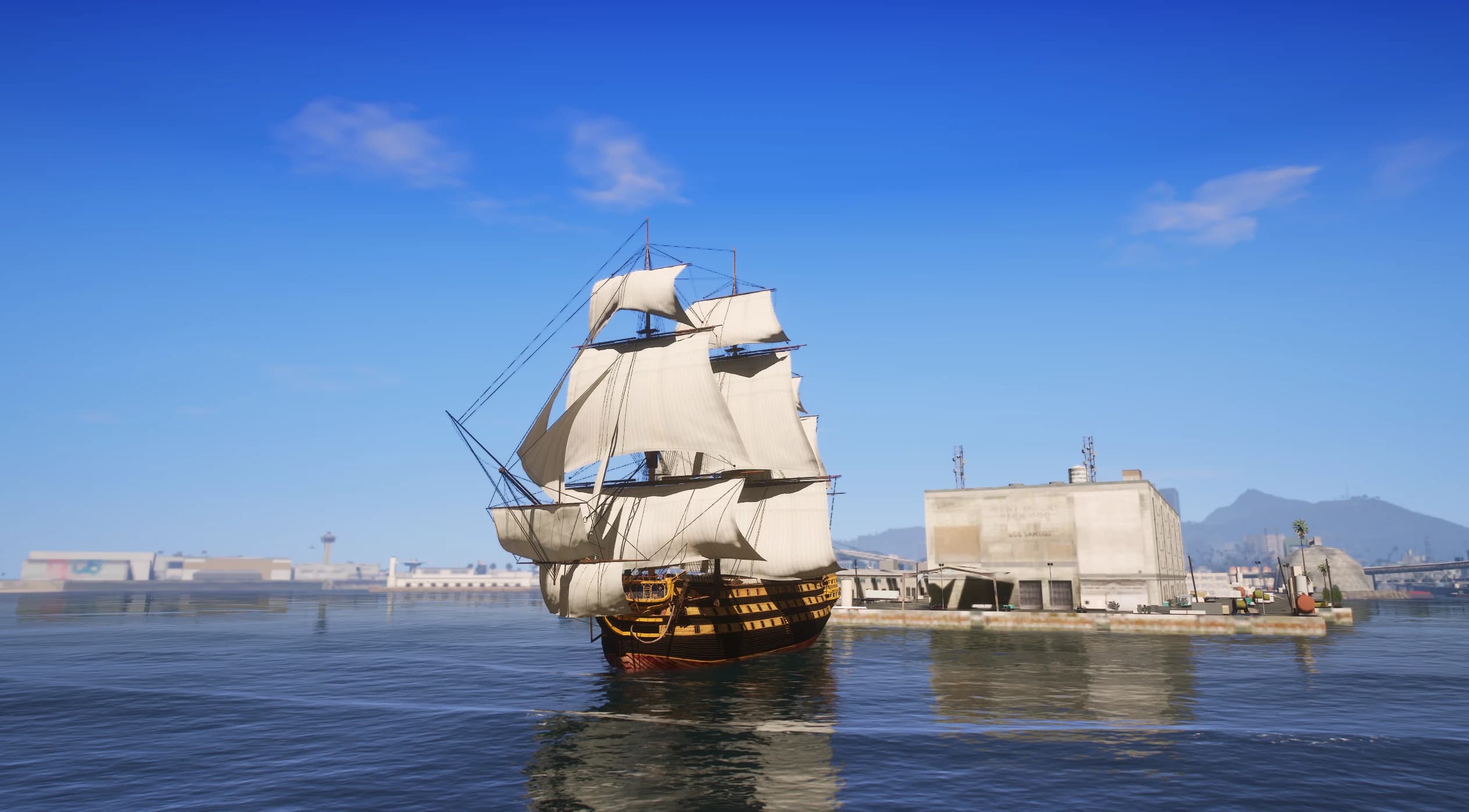 The 1765 HMS Victory tall ship under full sail in Los Santos harbour, showing its three masts and yellow-and-black gun-deck hull
