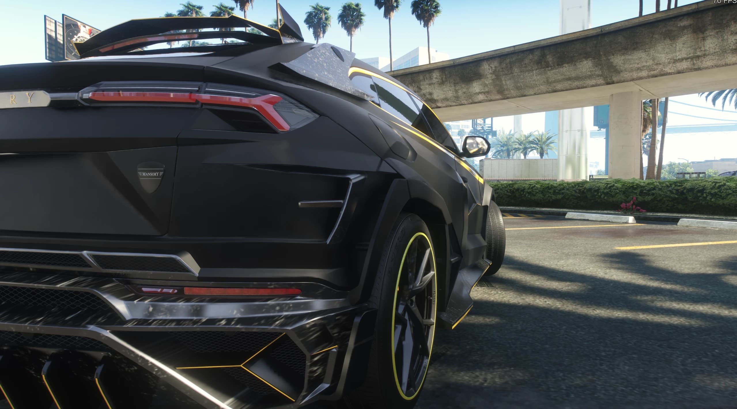 Close rear detail of the Mansory badge, Y shaped taillights and the carbon diffuser
