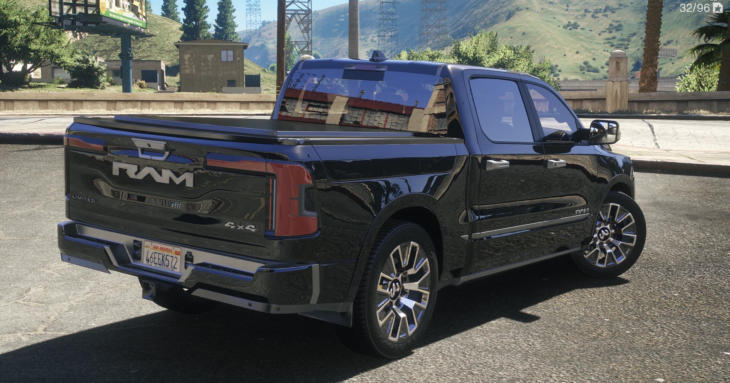 Rear three quarter view of the pickup with the RAM tailgate lettering, Limited and 4x4 badges and the bed cover fitted