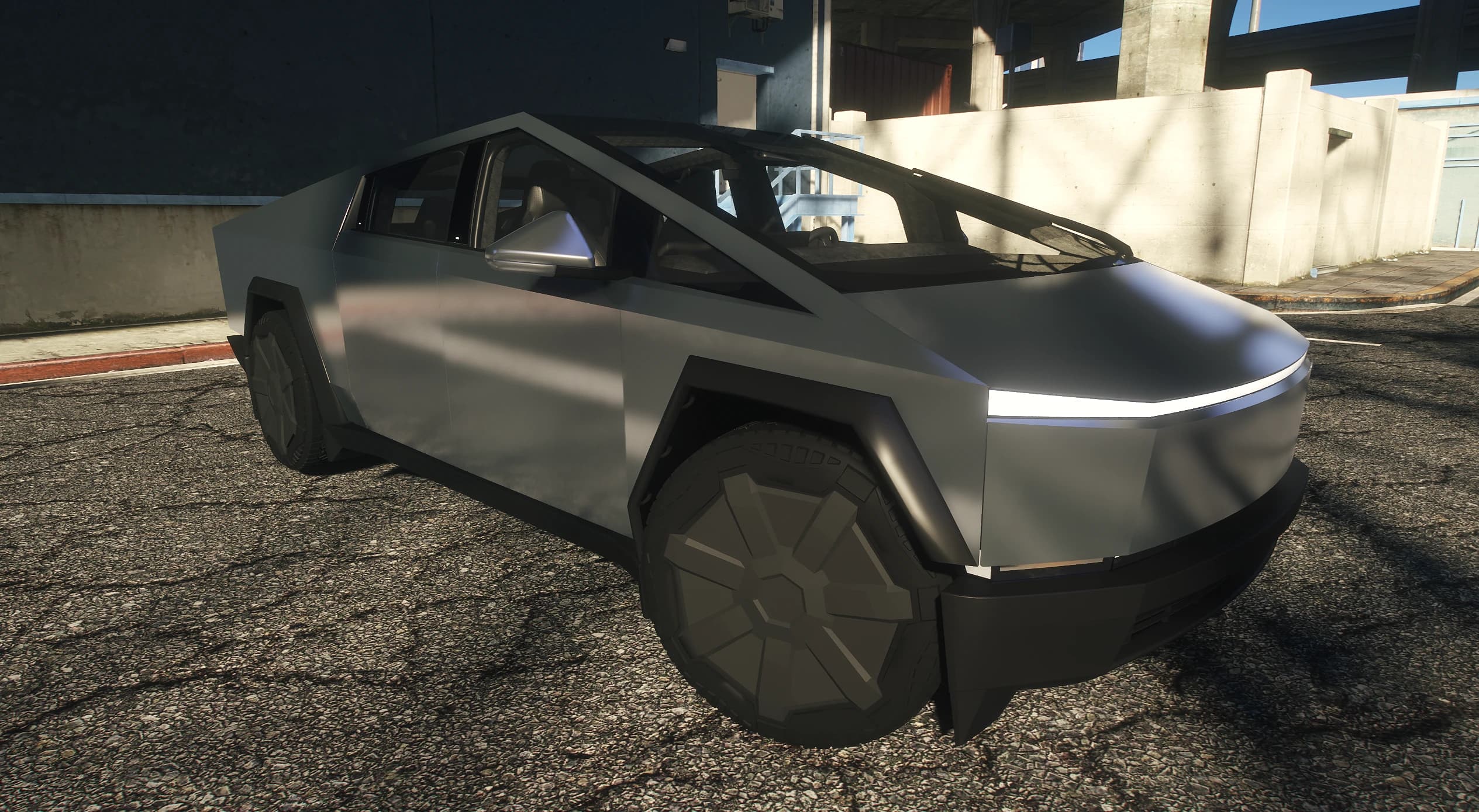 Front three quarter of the stainless Tesla Cybertruck with its full width light bar and angular wheel arches