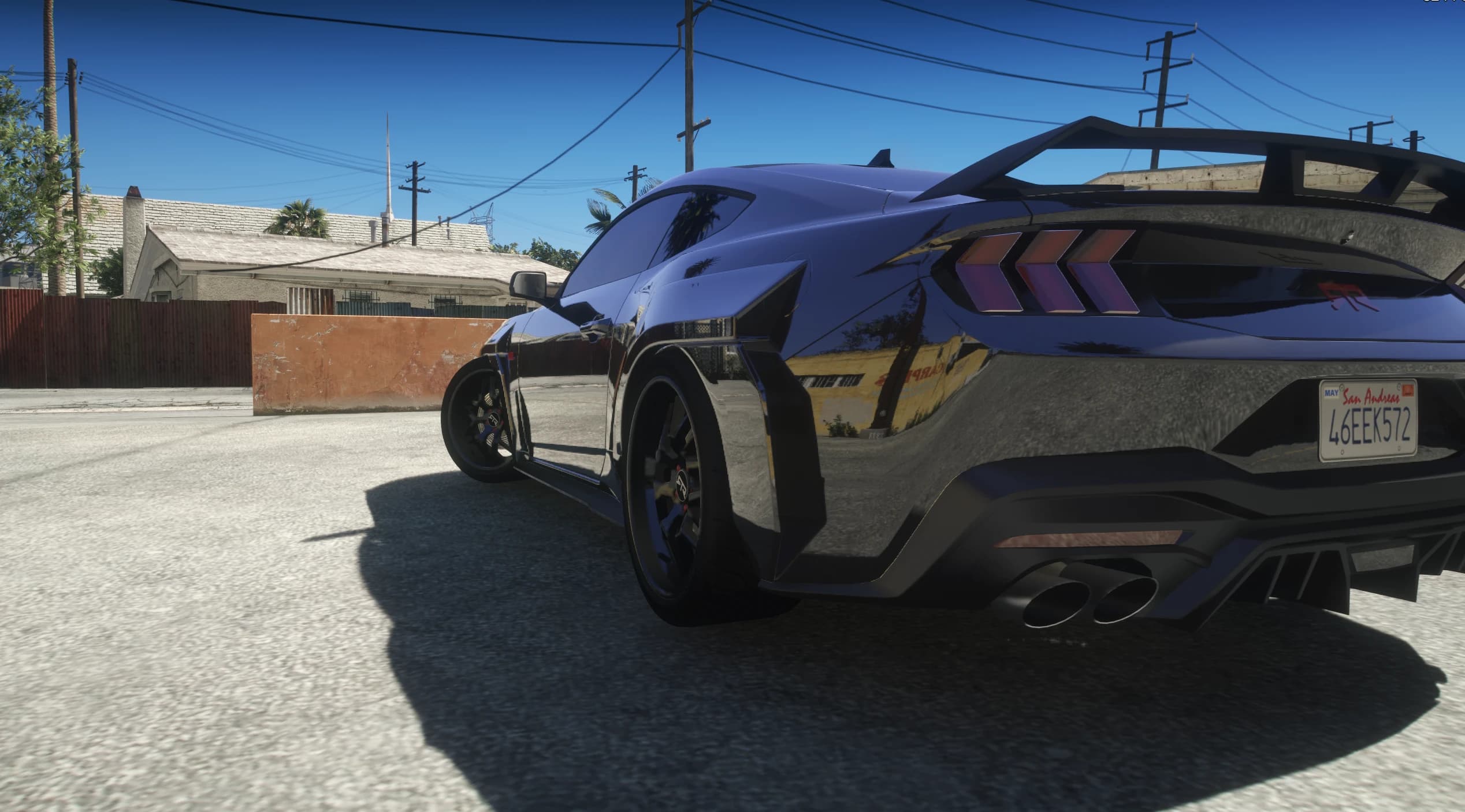 Low rear view of the Mustang RTR showing the wing, the arrow shaped taillights and the rear diffuser