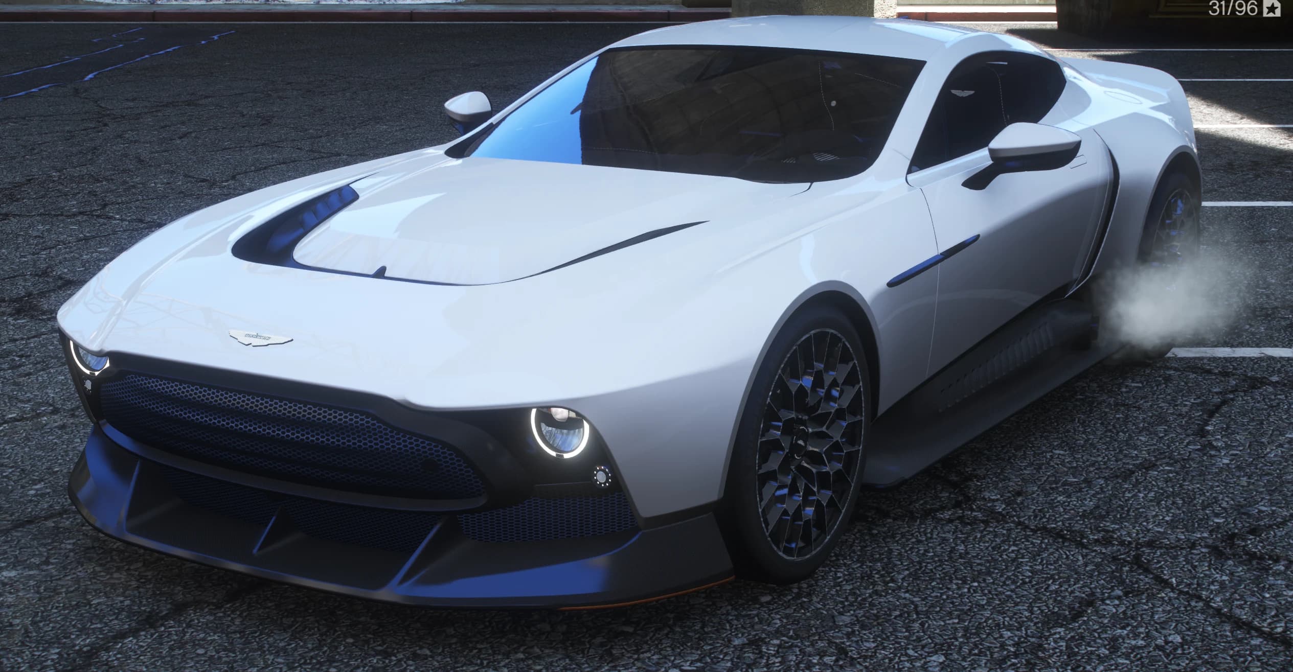 Front three quarter view of the pearl white Aston Martin Victor with round LED headlights, huge dark grille and lattice wheels