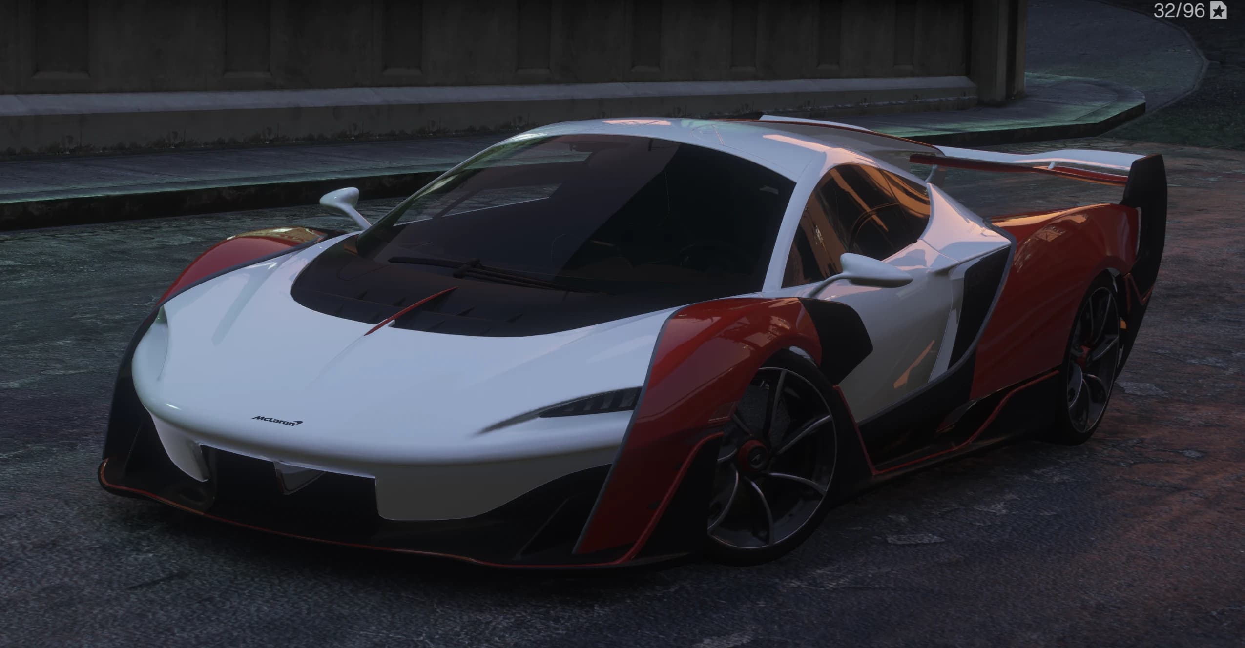 Front three quarter view of the white and red McLaren Sabre with carbon accents and the twin element rear wing