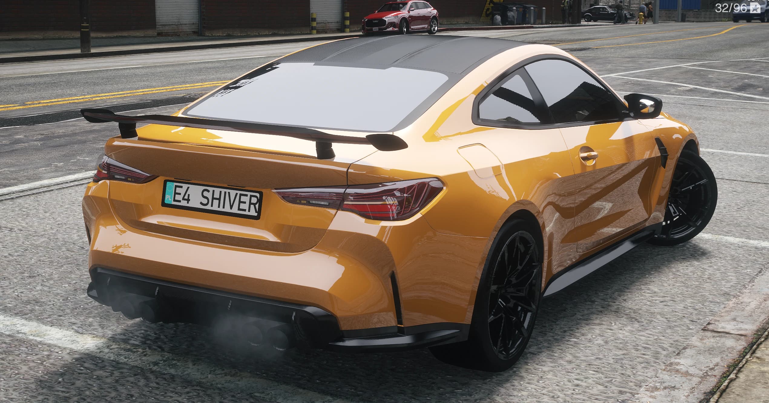 Rear three quarter view of the M4 with the black wing, LED taillights, quad exhaust tips and rear diffuser