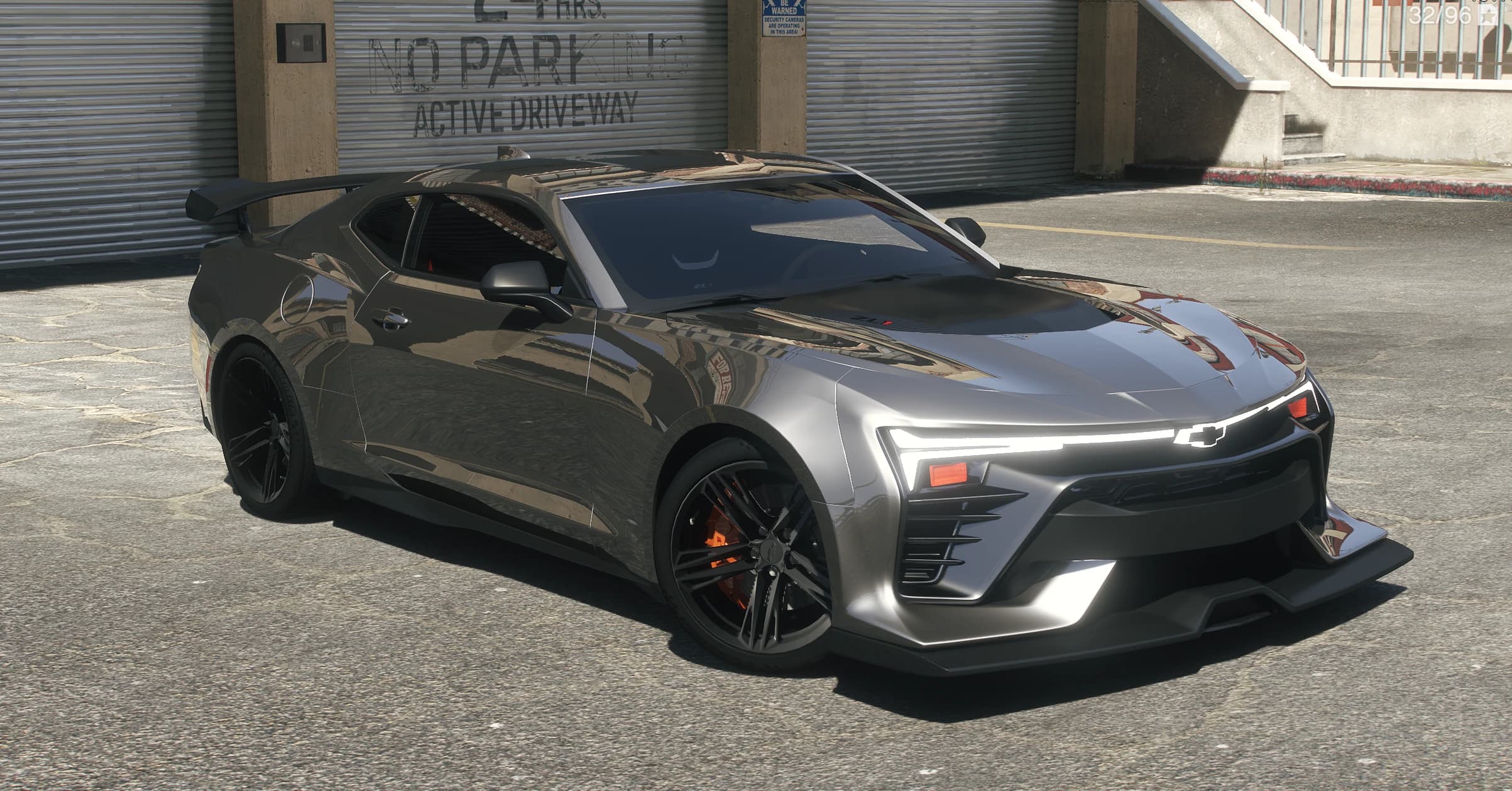 Front three quarter view of the gunmetal Camaro ZL1 with the full width LED light bar, bowtie emblem and orange brake calipers
