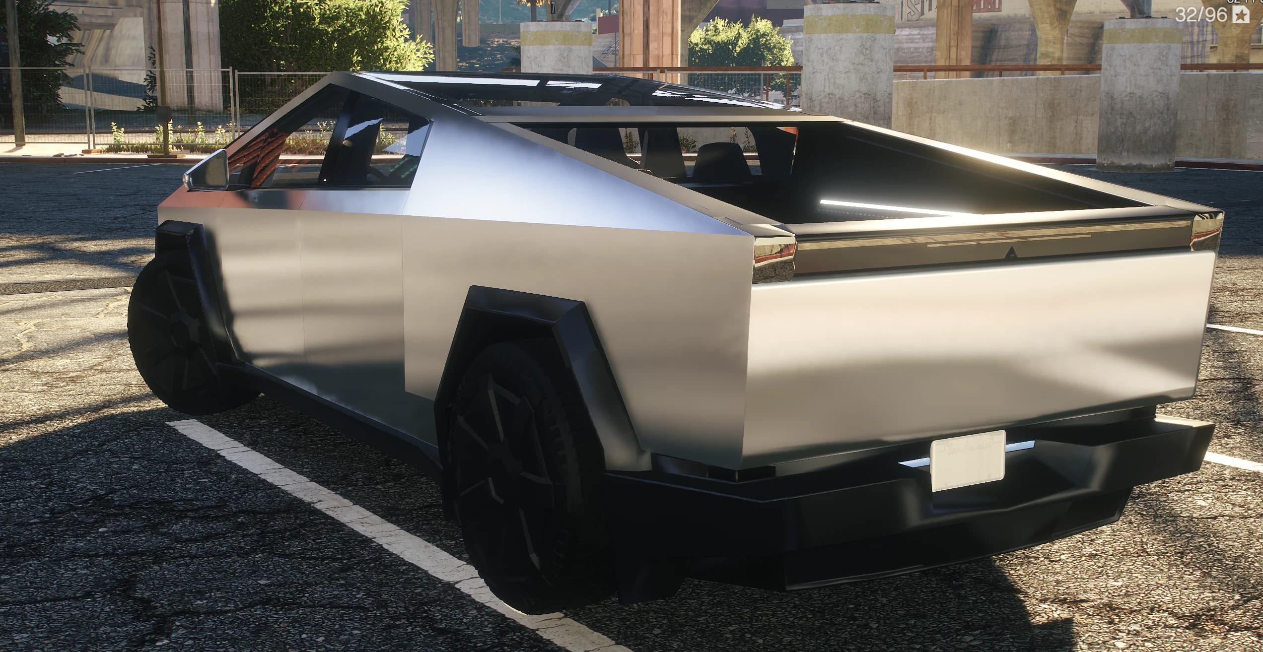Rear three quarter of the Cybertruck showing the open bed, the tonneau rails and the rear light bar