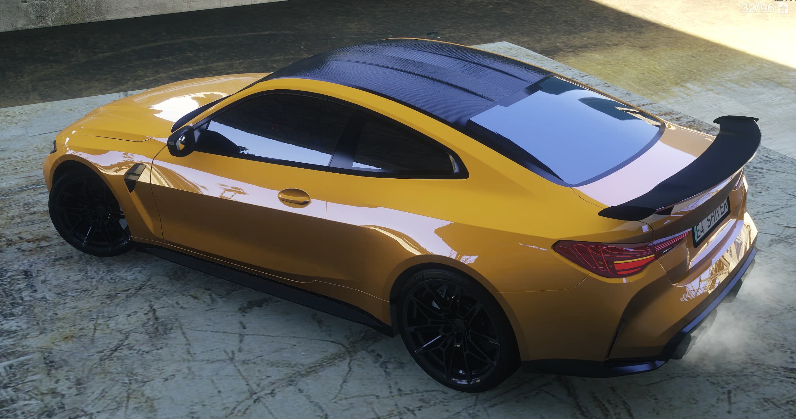 Top side view of the M4 showing the carbon fiber roof, the rear wing and Michelin lettering on the tires