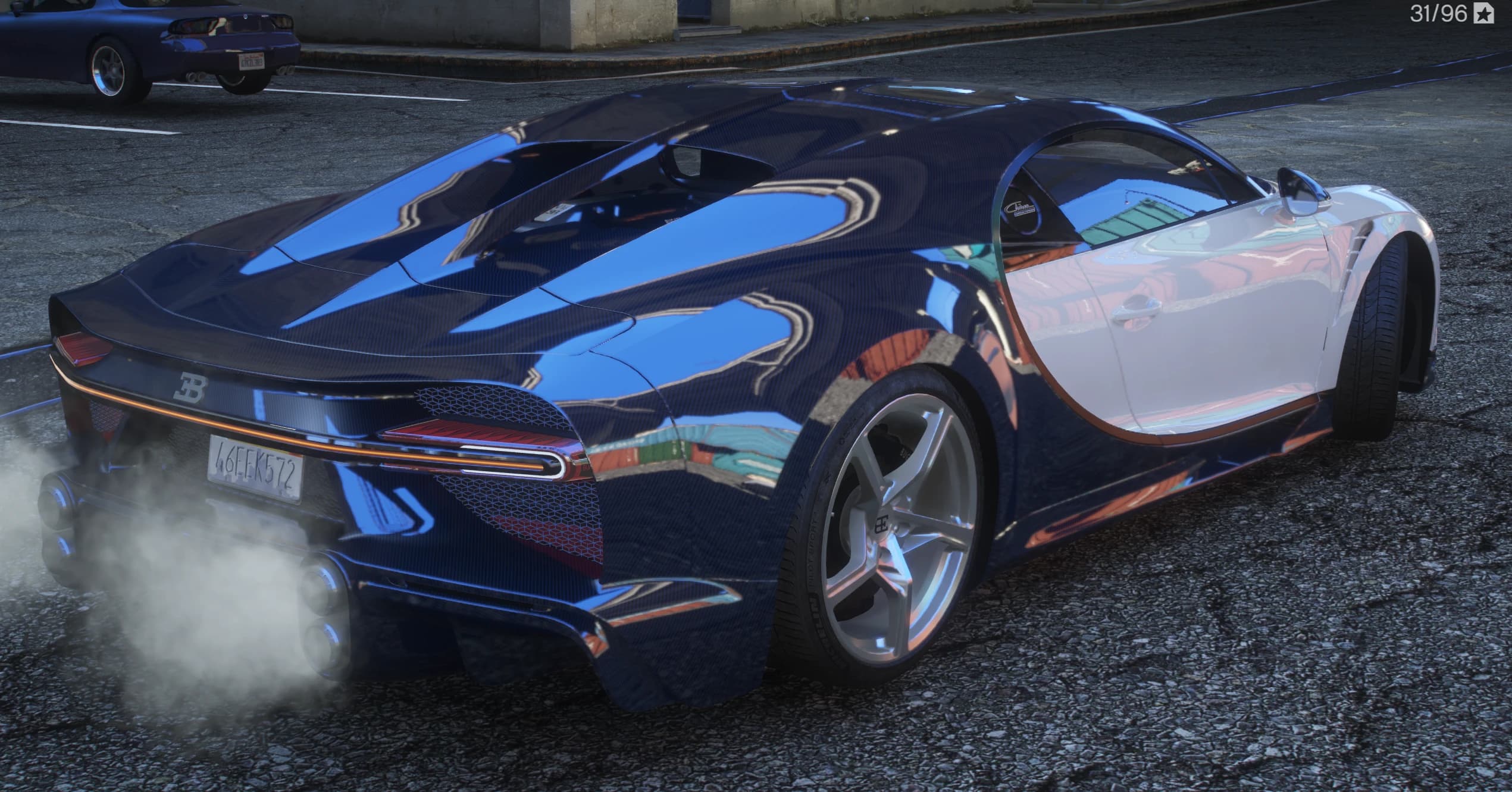 Rear three quarter view of the longtail rear in exposed blue carbon with stacked centre exhausts and the full width light bar