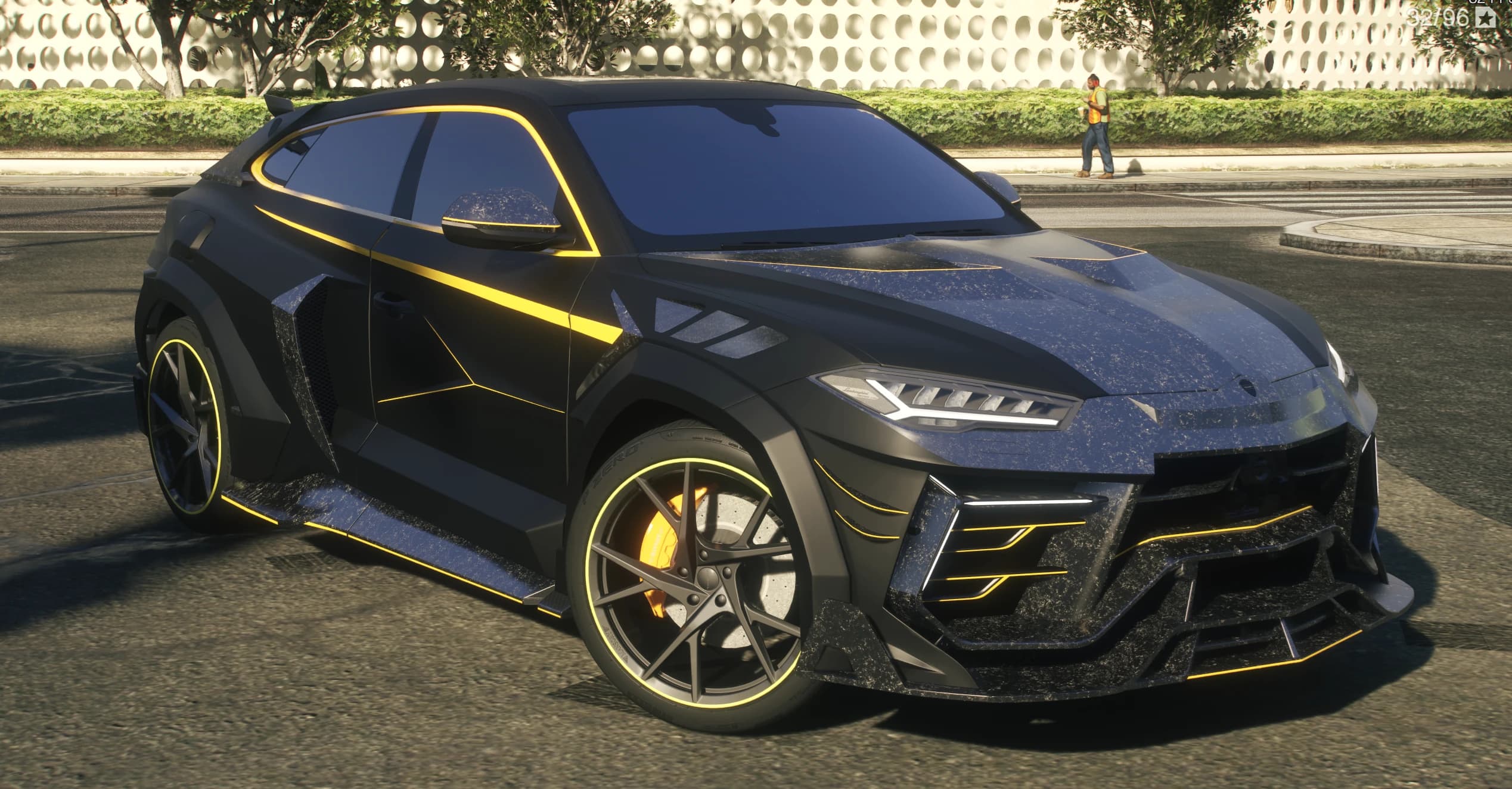 Front three quarter view of the matte black Mansory Urus with yellow pinstripes, carbon canards and yellow calipers