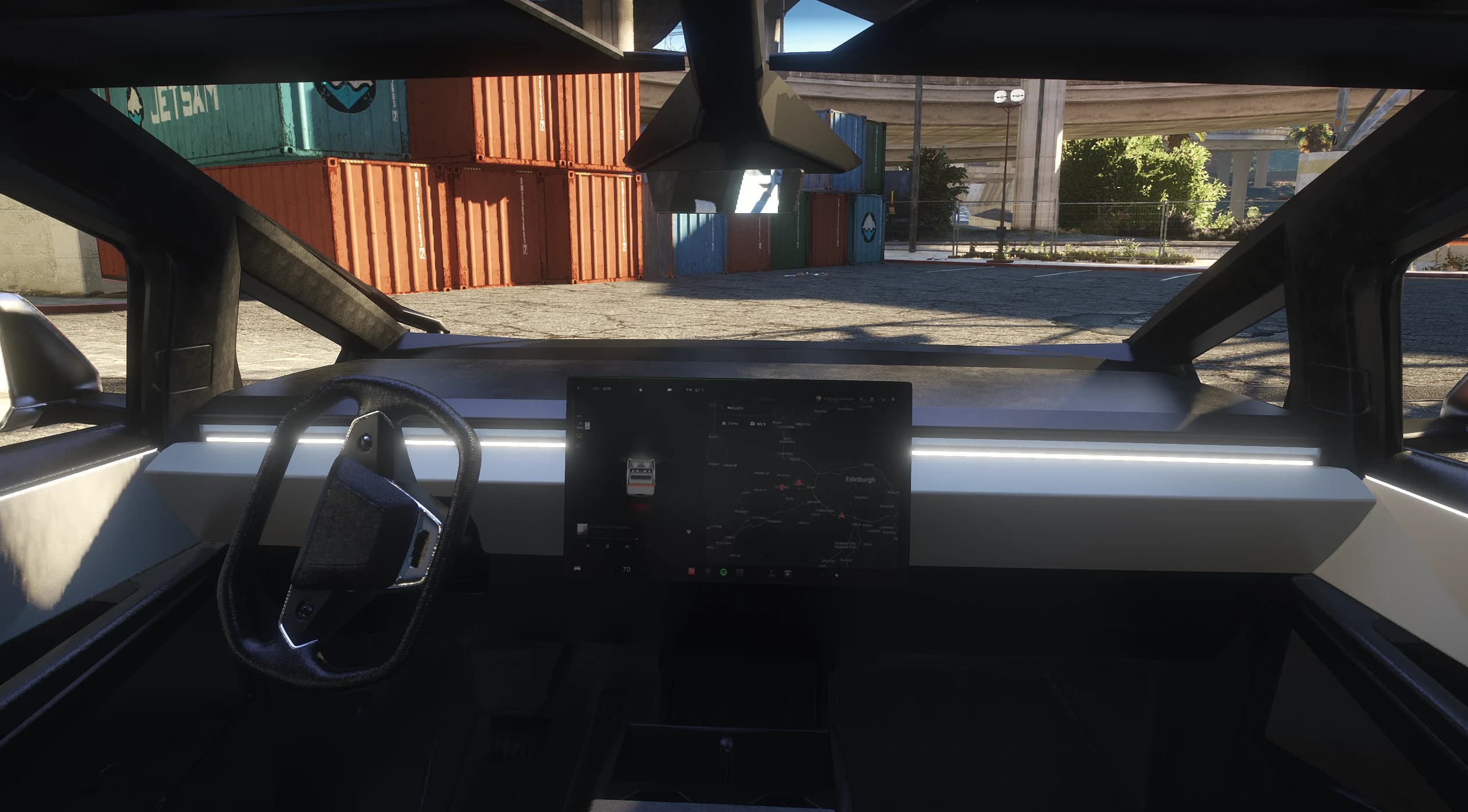 First person interior of the Cybertruck with the yoke steering wheel and the large landscape touchscreen