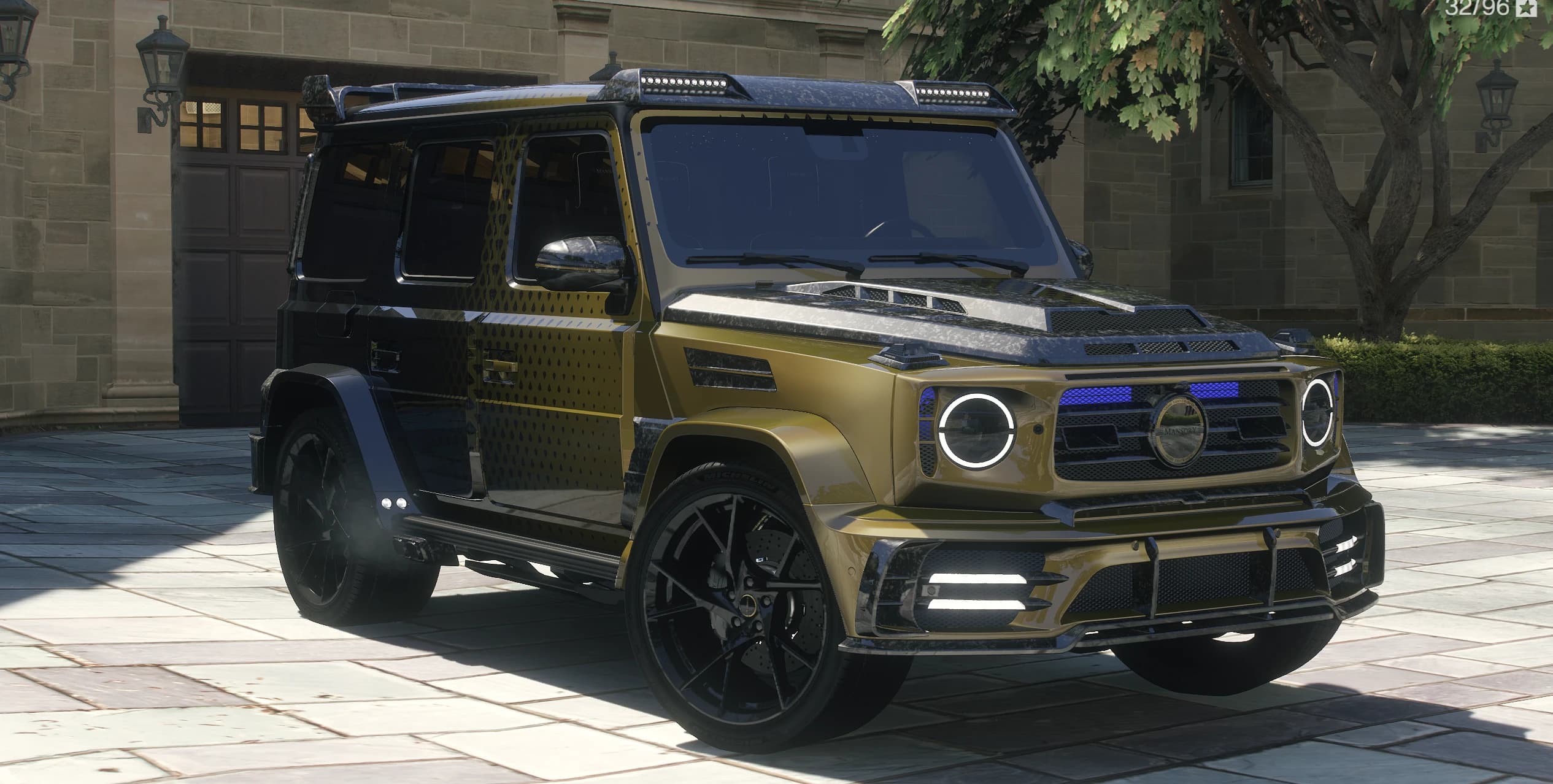 Front three quarter view of the Mansory G63 in olive gold and black with the fade pattern and forged carbon parts