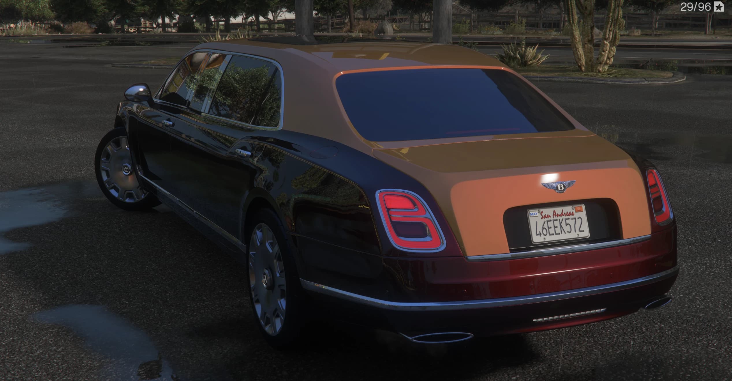Rear three-quarter of the two-tone Mulsanne showing the winged Bentley badge on the boot, the tall taillights and the spoke wheels