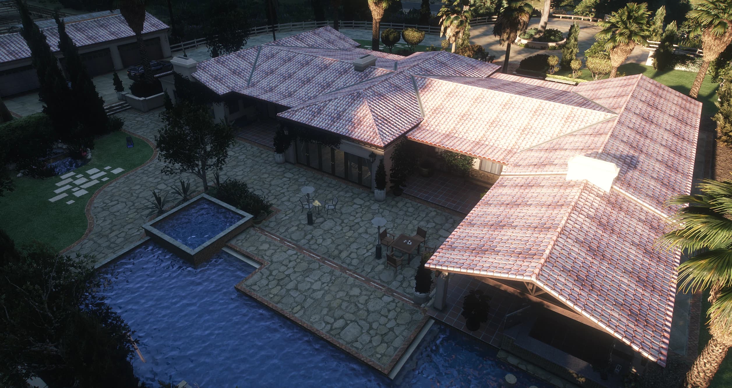 Aerial view of the back patio with the pool, the jacuzzi and the garage block