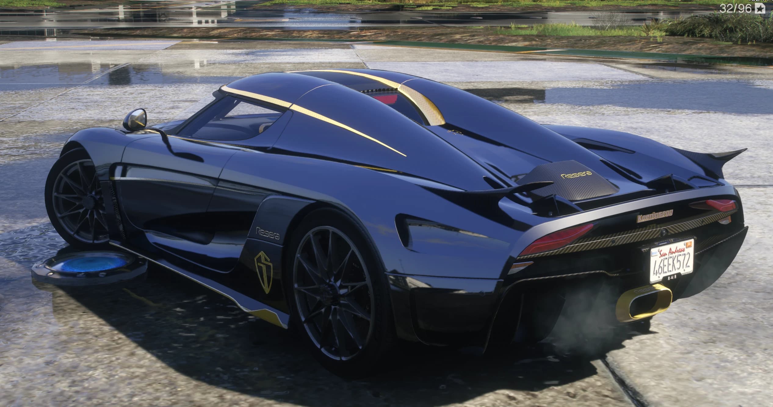 Rear three quarter view of the Regera with the active wing raised, carbon engine cover and gold exhaust outlet
