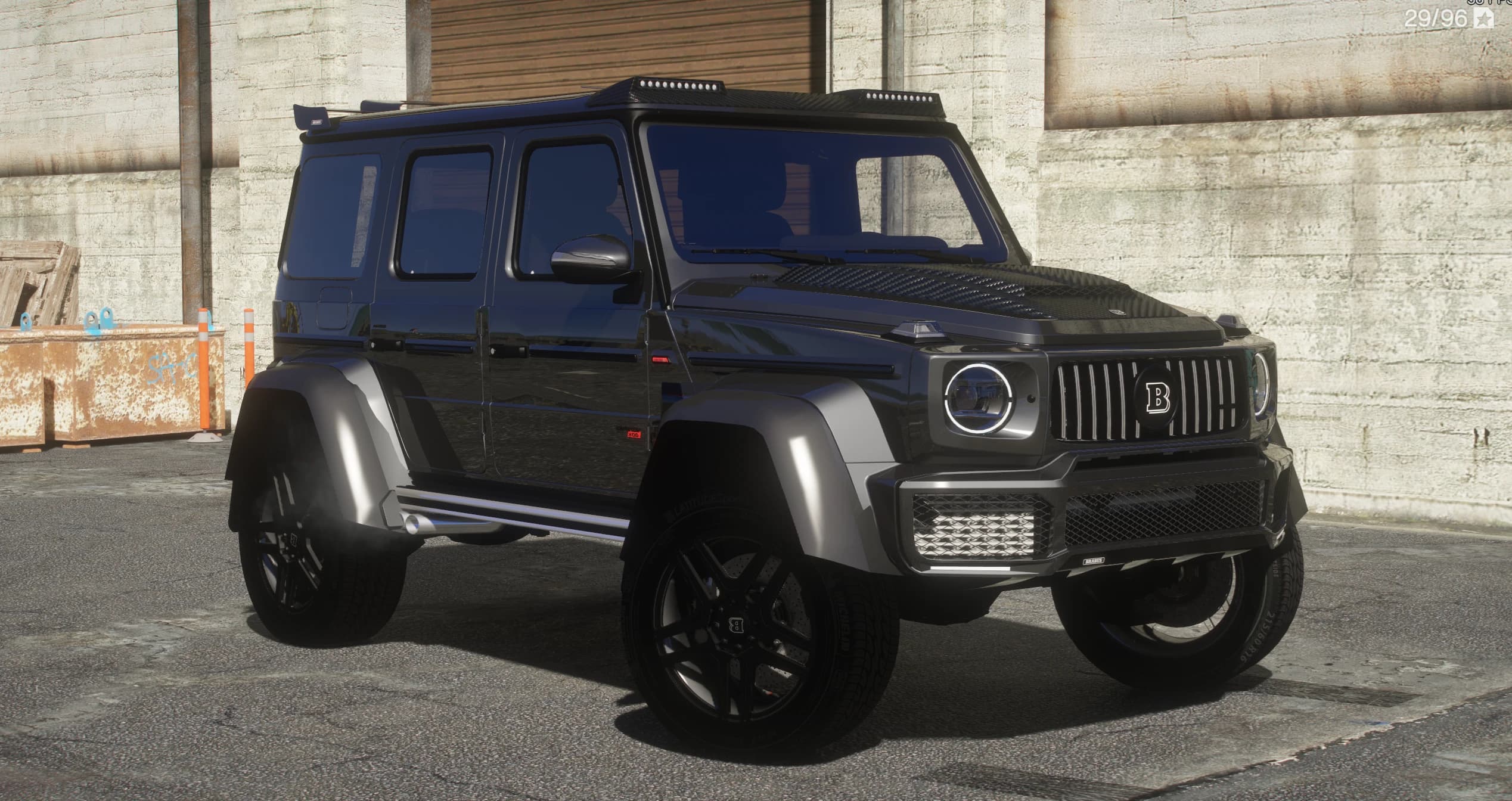 Black Mercedes G800 Brabus 4x4 with carbon bonnet, silver widened fenders and black Brabus wheels, front three-quarter view in front of a warehouse