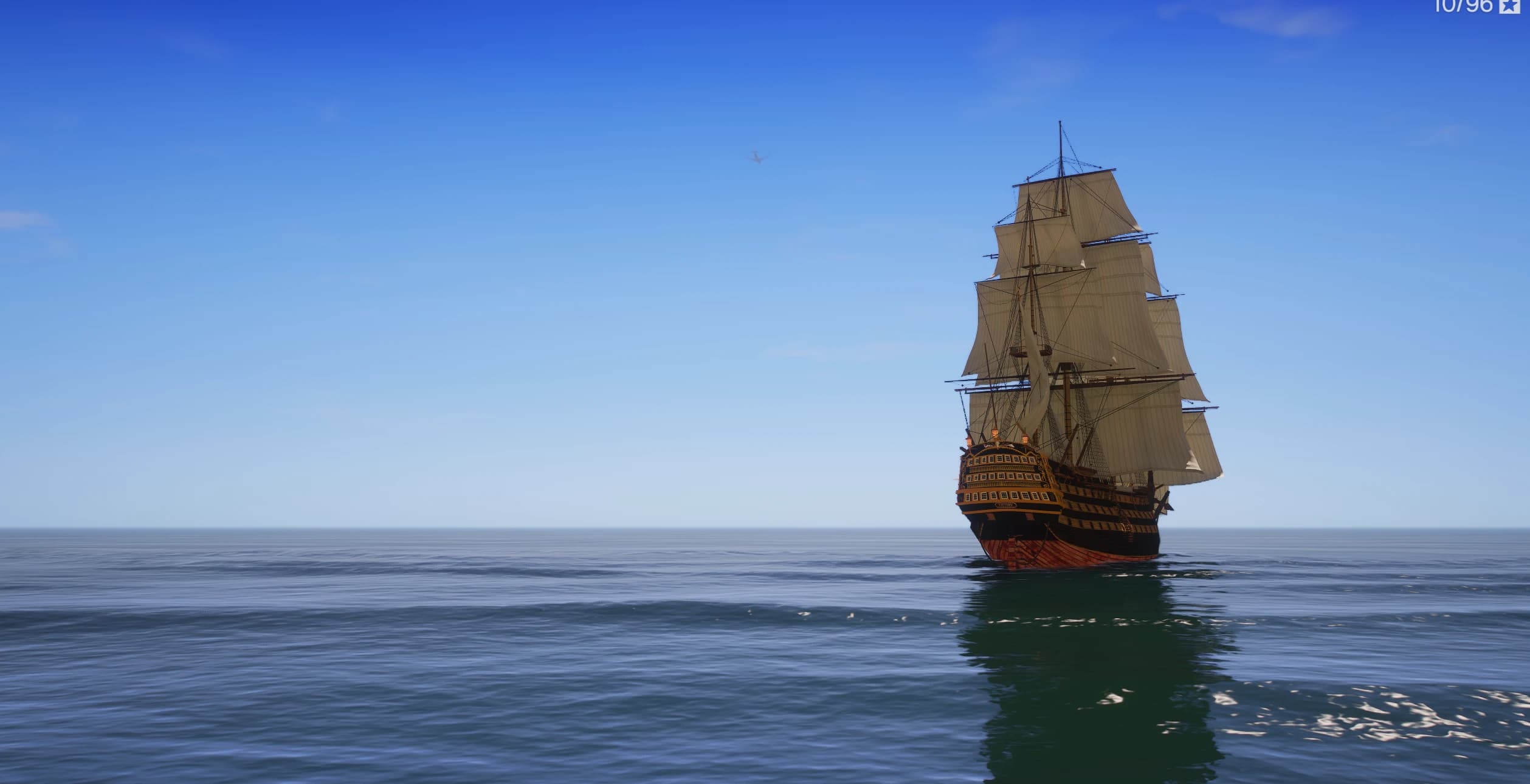 HMS Victory sailing on the open sea under a clear sky, seen from a distance
