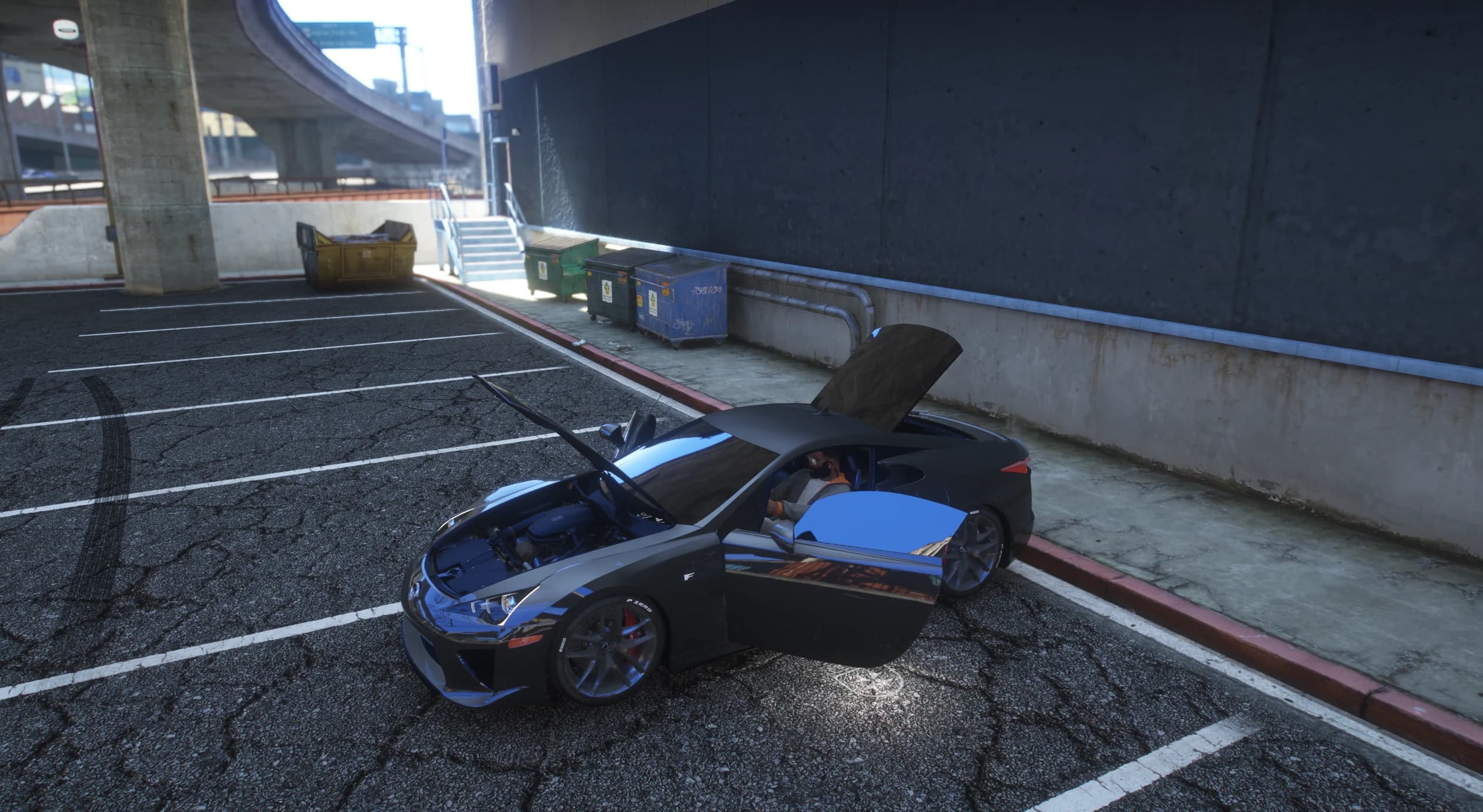 Overhead view of the LFA in a parking lot with the hood open over the V10 and both doors swung out
