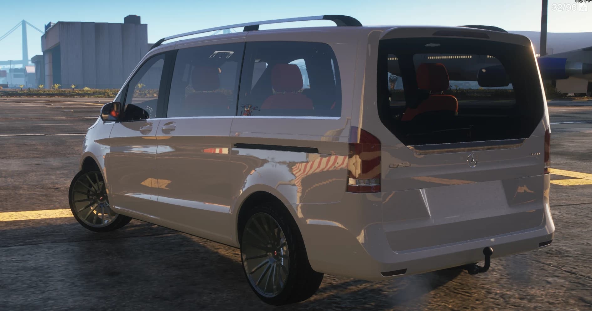 Rear three quarter view at the docks showing the roof rails, tow hitch, tailgate glass and the red captain chairs through the windows